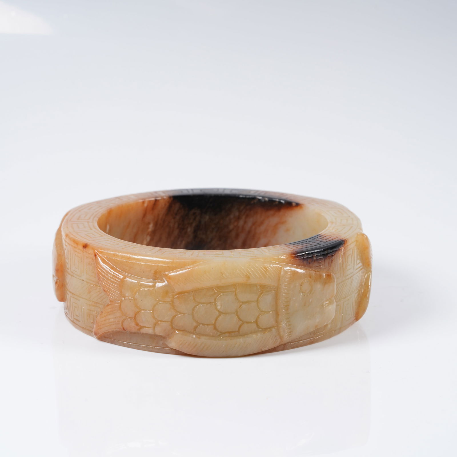 A ANCIENT JADE BRACELET WITH FISH MOTIF: Ancient jade bracelet with fish motif
