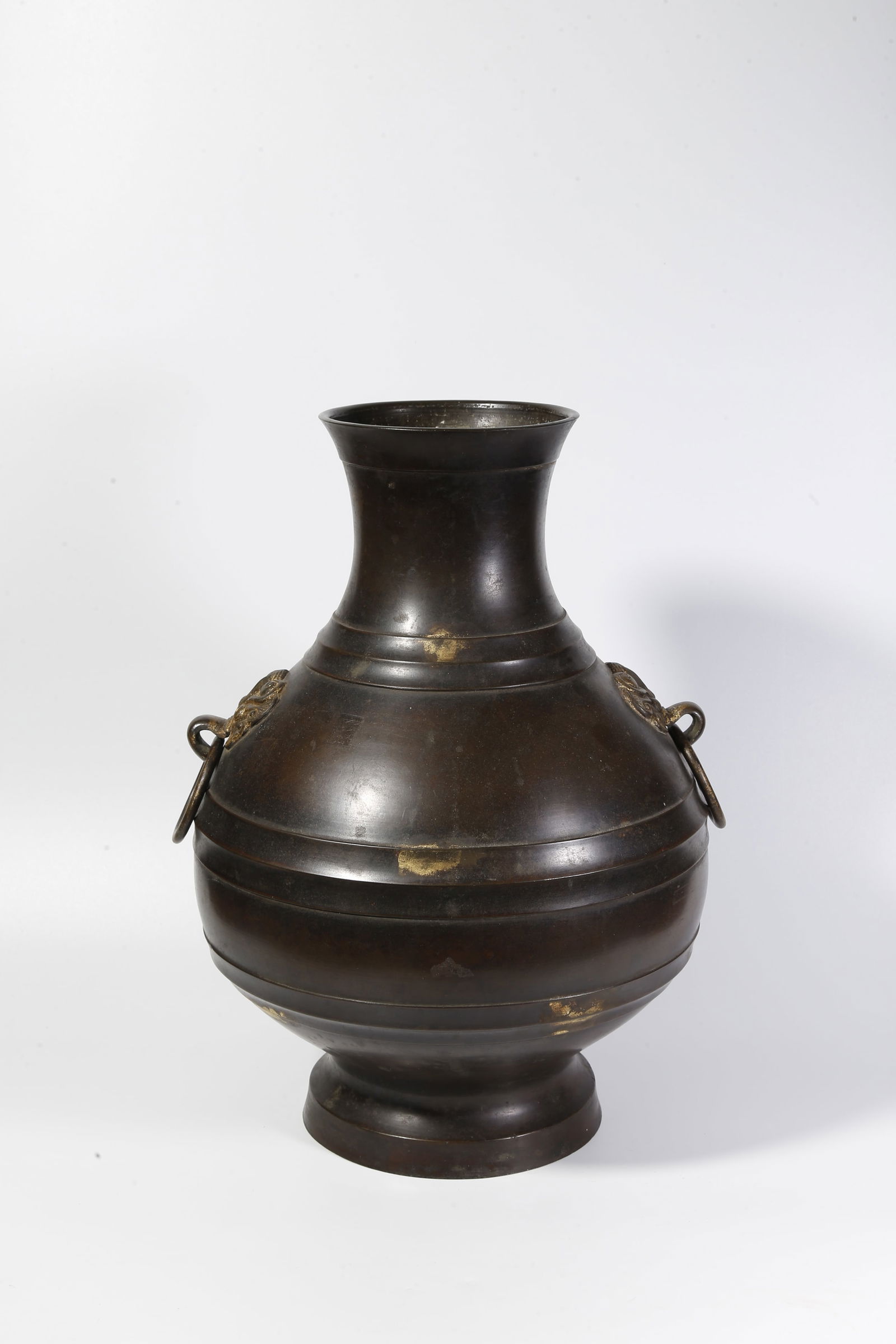 A BRONZE DOUBLE-RING-HANDLED BOTTLE: Bronze double-ring-handled bottle