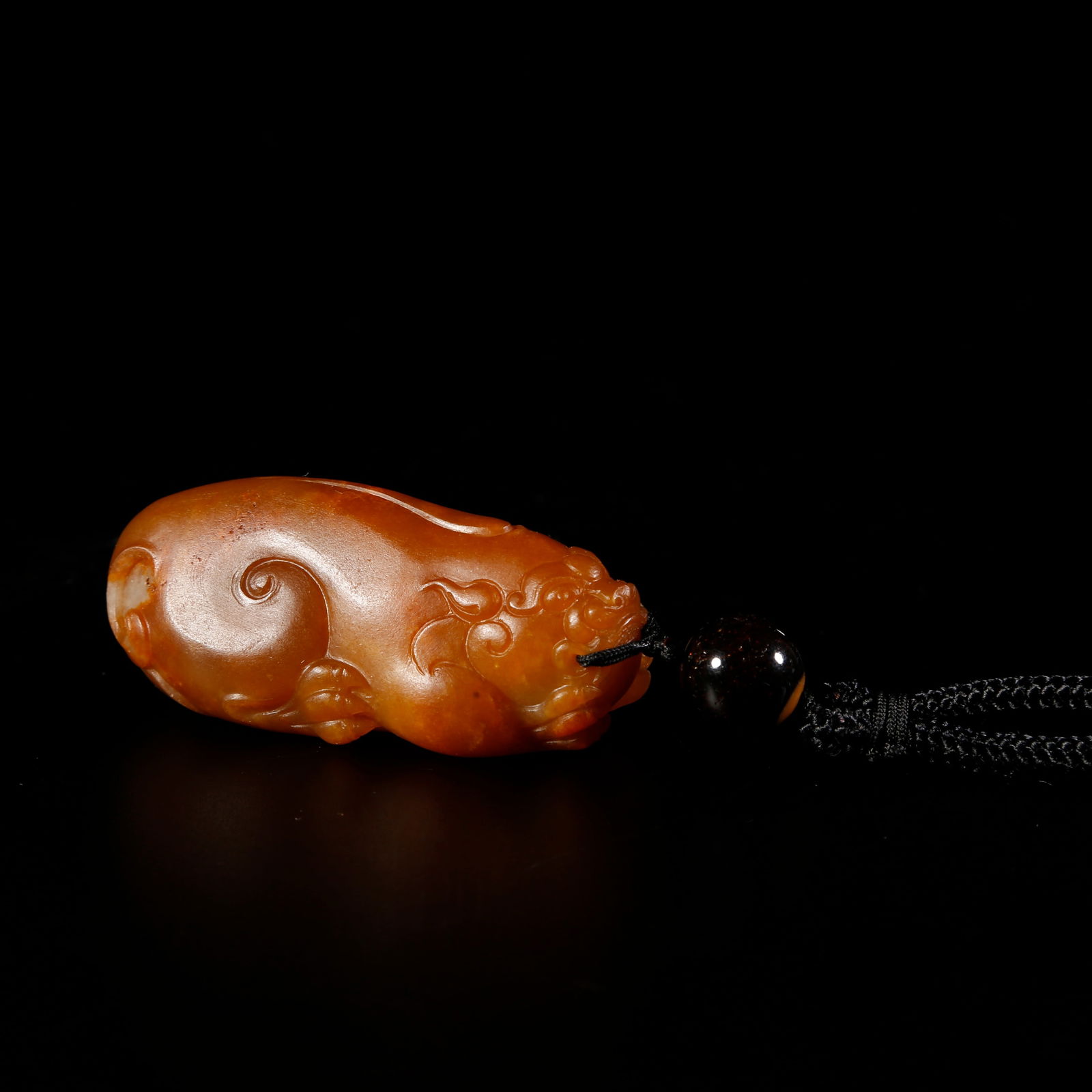 A HETIAN JADE LION-SHAPED PENDANT: Hetian jade lion-shaped pendant