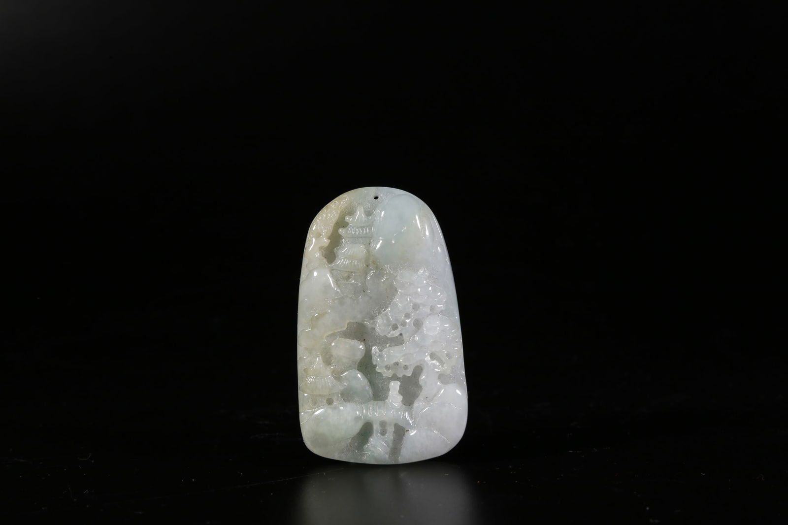 A JADEITE PENDANT WITH LANDSCAPE MOTIF: Jadeite pendant with landscape motif