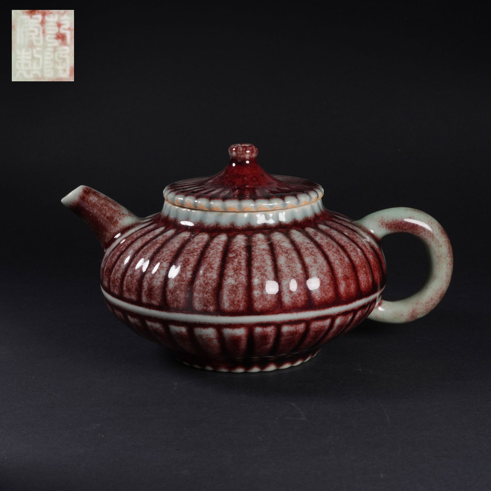 A FLAMBÉ-GLAZED CHRYSANTHEMUM-PETAL TEAPOT: Flambé-glazed chrysanthemum-petal teapot