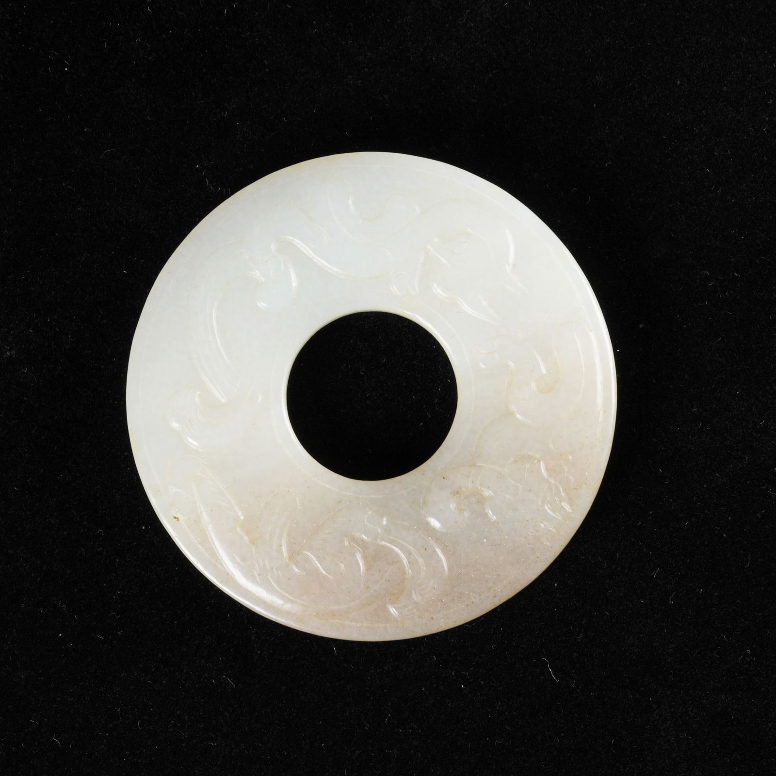 A HETIAN JADE RING WITH CHI DRAGON MOTIF: Hetian jade ring with chi dragon motif