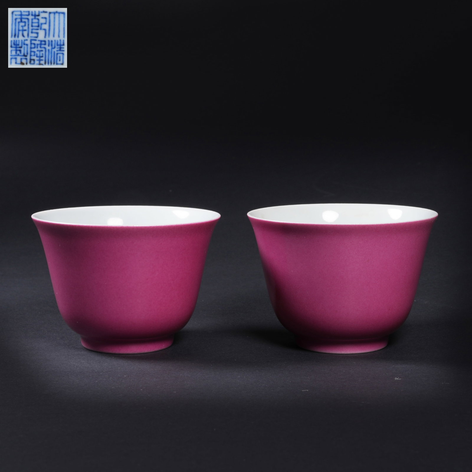 A SET OF CUPS WITH RUBY-RED EXTERIOR AND BLUE-AND-WHITE CLOUD-AND-DRAGON INTERIOR: Set of cups with ruby-red exterior and blue-and-white cloud-and-dragon interior