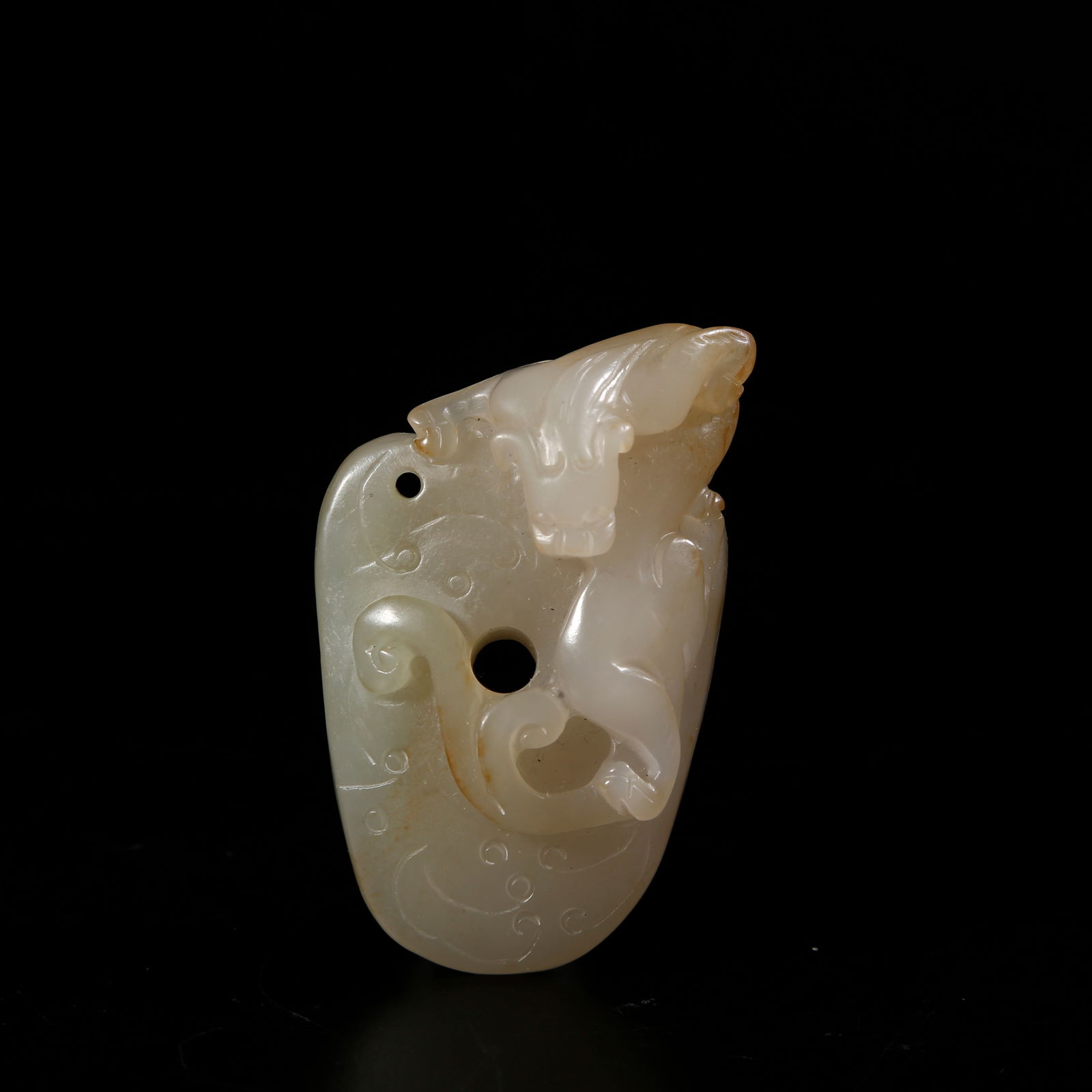 A HETIAN JADE PENDANT WITH DRAGON MOTIF: Hetian jade pendant with dragon motif