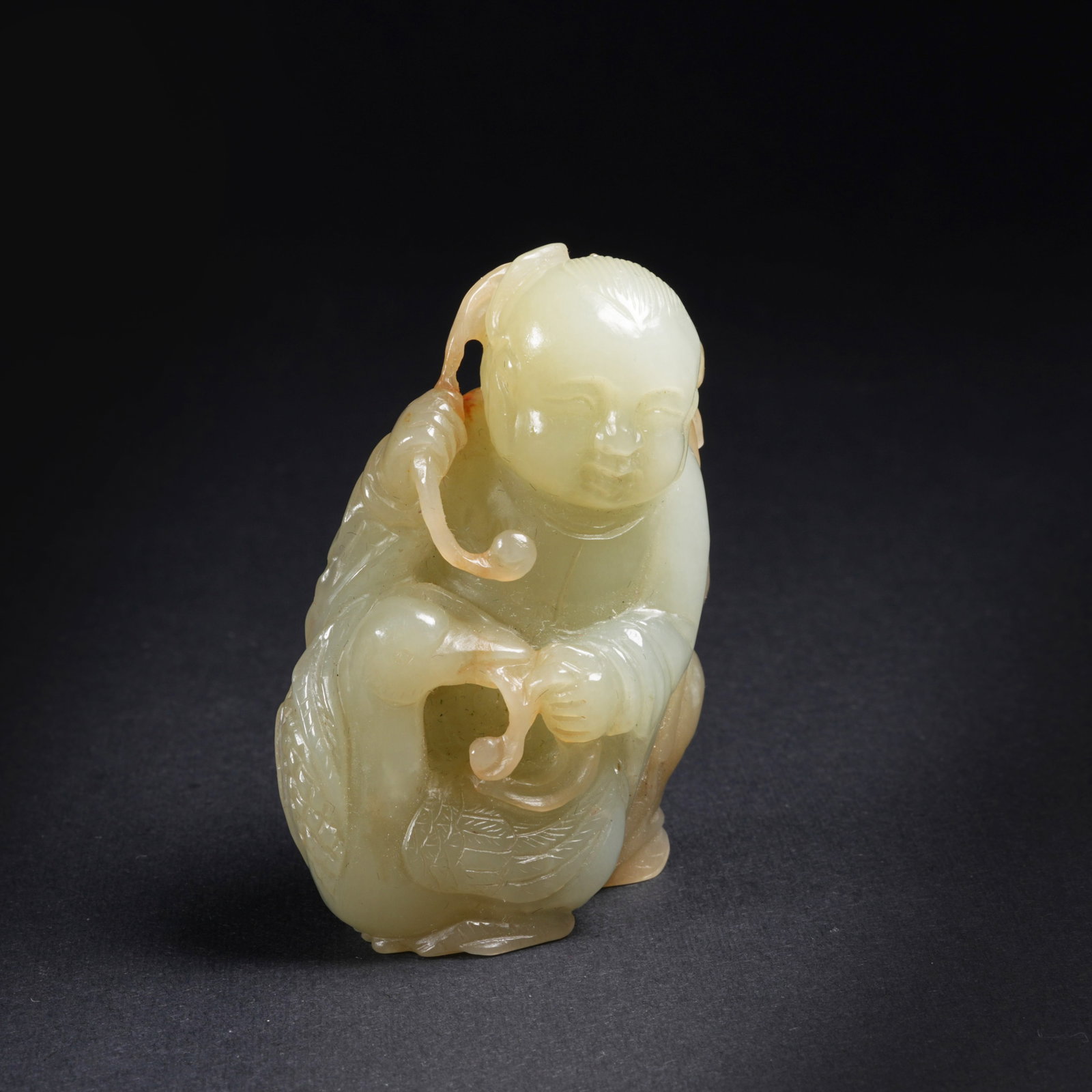 A HETIAN JADE BOY PLAYING WITH GOOSE PENDANT: Hetian jade boy playing with goose pendant