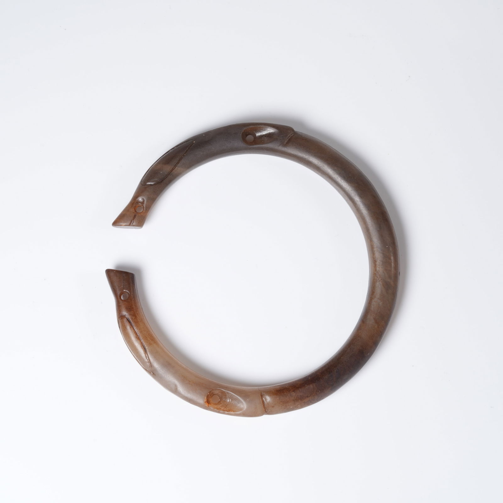 A ANCIENT JADE DRAGON-SHAPED BRACELET: Ancient jade dragon-shaped bracelet