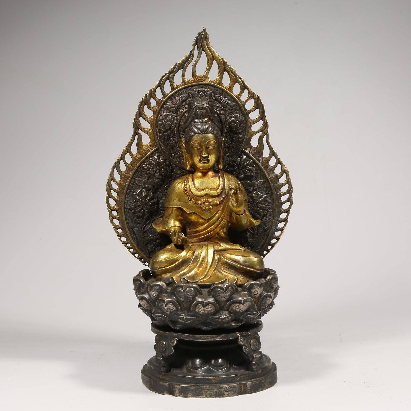 A SILVER PARTIAL GILDED SHAKYAMUNI BUDDHA STATUE: Silver Partial Gilded Shakyamuni Buddha Statue