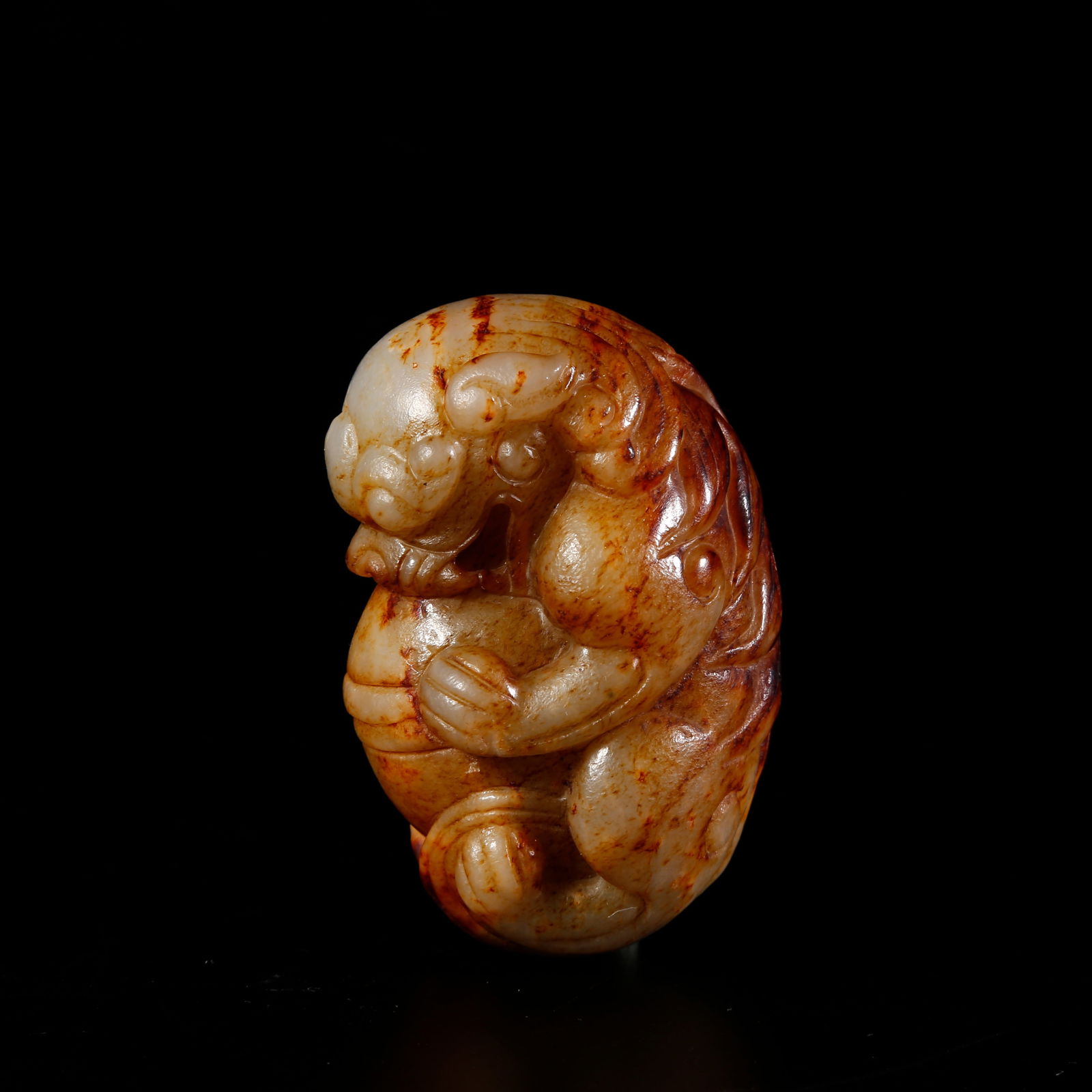 A HETIAN JADE LION-SHAPED ORNAMENT: Hetian jade lion-shaped ornament