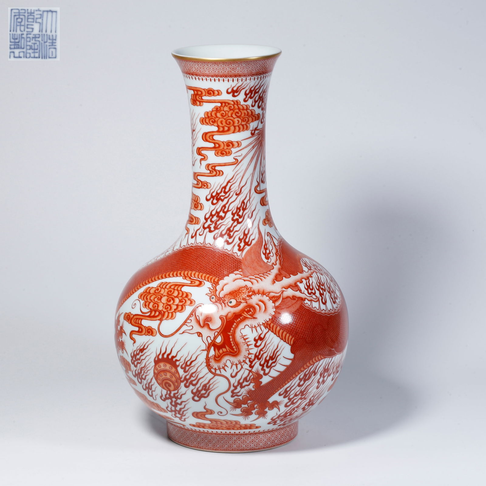 A UNDERGLAZE RED VASE WITH CLOUD AND DRAGON DESIGN: Underglaze red vase with cloud and dragon design