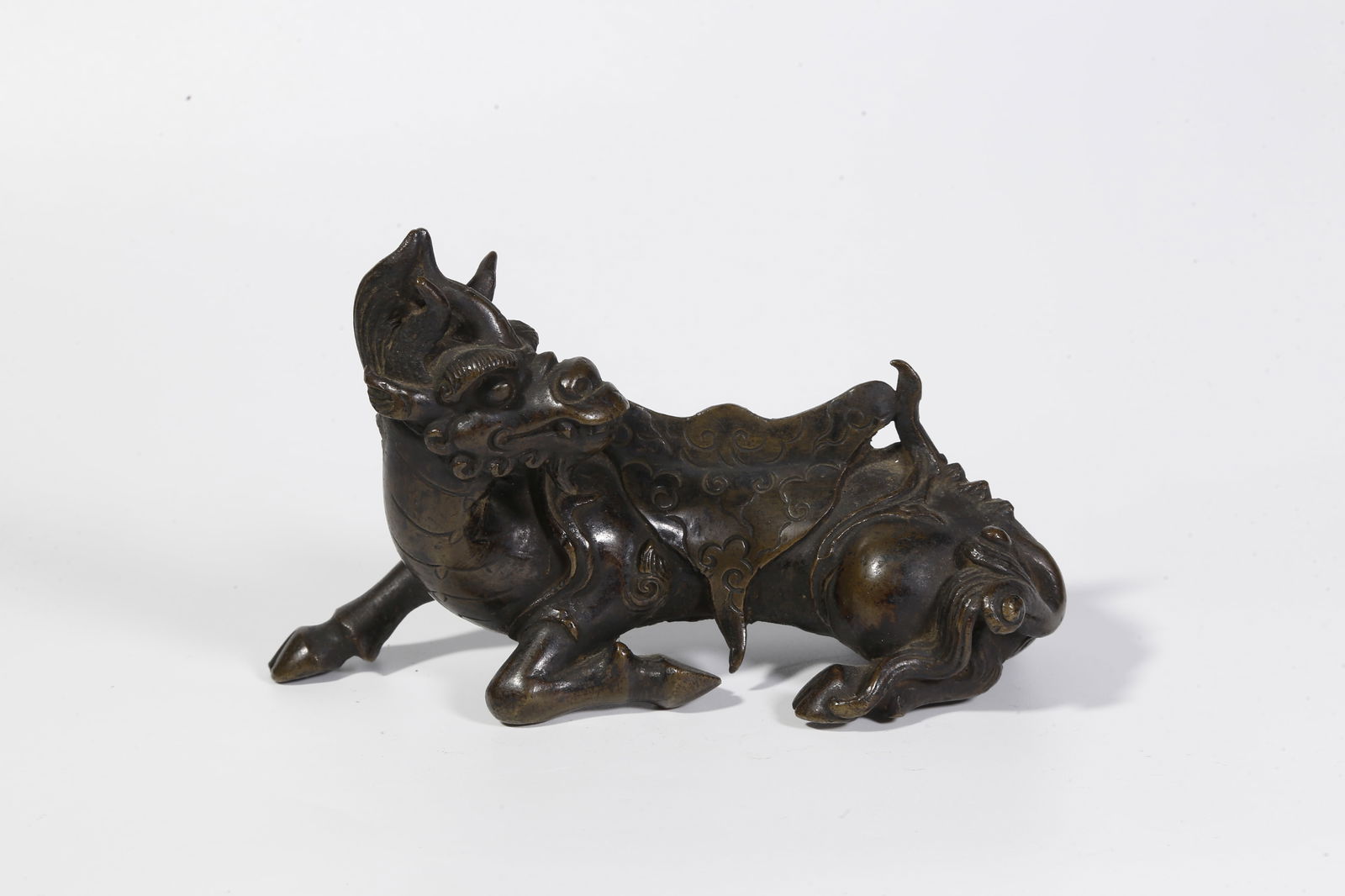 A BRONZE BEAST-SHAPED ORNAMENT: Bronze beast-shaped ornament
