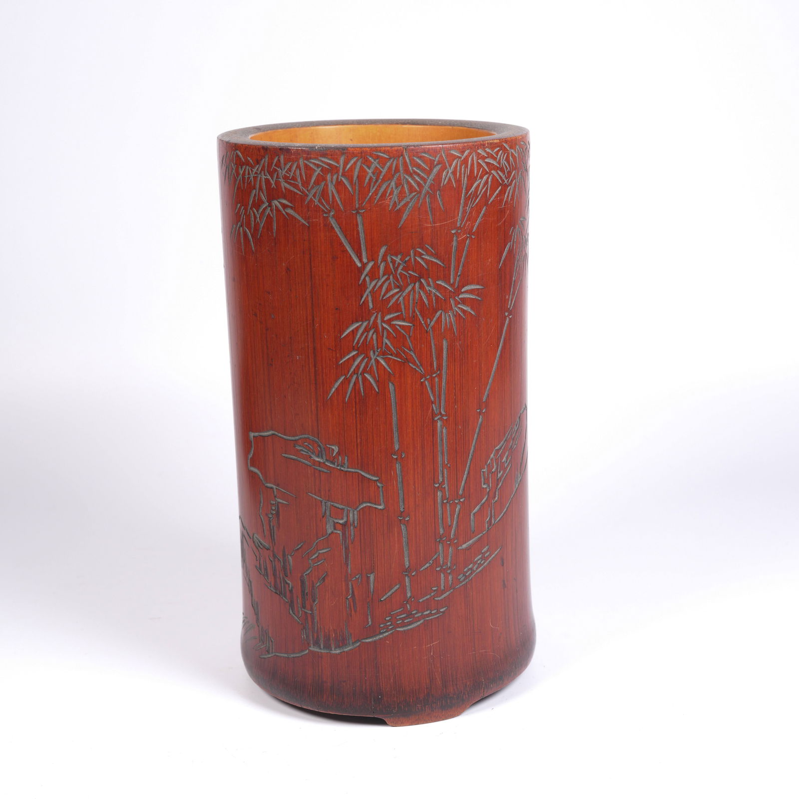 A BAMBOO-CARVED BRUSH POT WITH BAMBOO FOREST AND SCHOLAR’S ROCK MOTIF: Bamboo-Carved Brush Pot with Bamboo Forest and Scholar’s Rock Motif