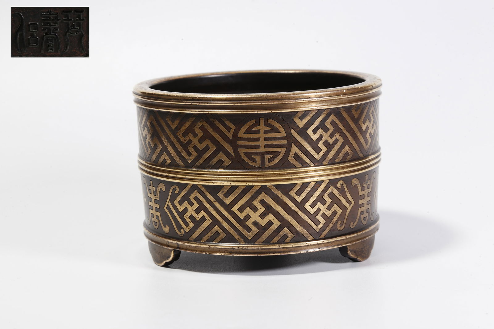 A GILT-BRONZE THREE-LEGGED INCENSE BURNER: Gilt-bronze three-legged incense burner