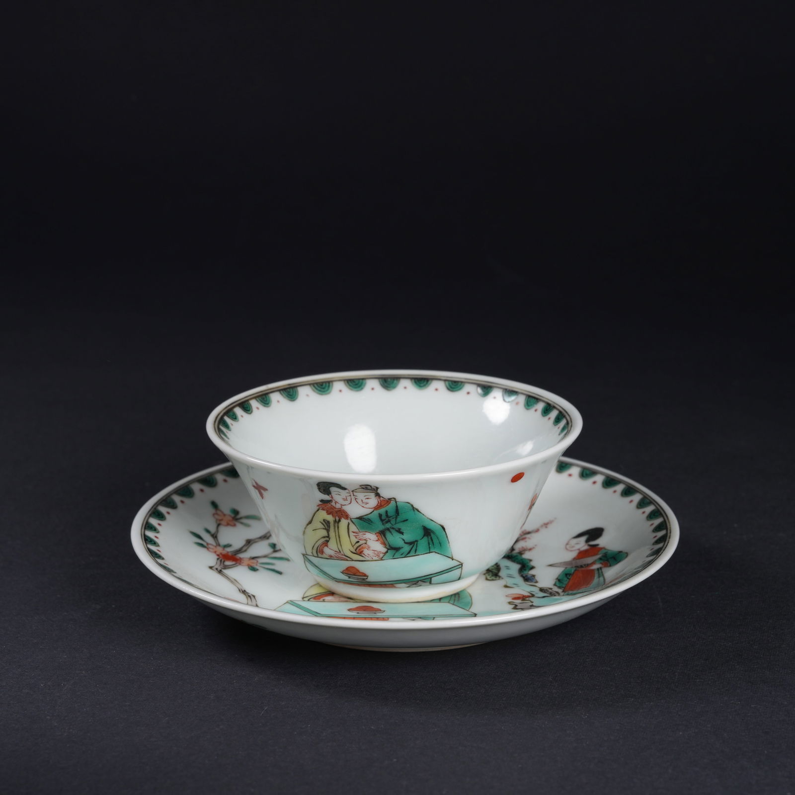 A SET OF WUCAI FIGURAL CUP-AND-SAUCER SETS: Set of wucai figural cup-and-saucer sets
