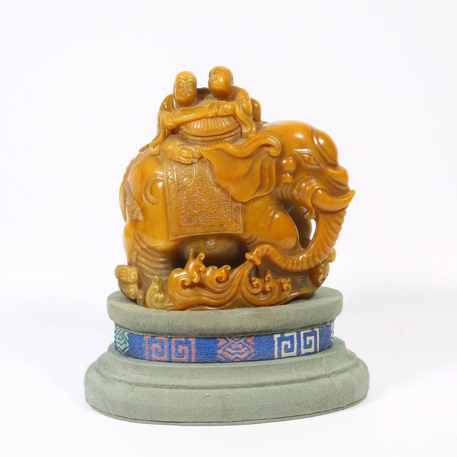 A SHOUSHAN STONE SEAL WITH ARHAT PLAYING WITH ELEPHANT-SHAPED KNOB: Shoushan stone seal with Arhat playing with elephant-shaped knob