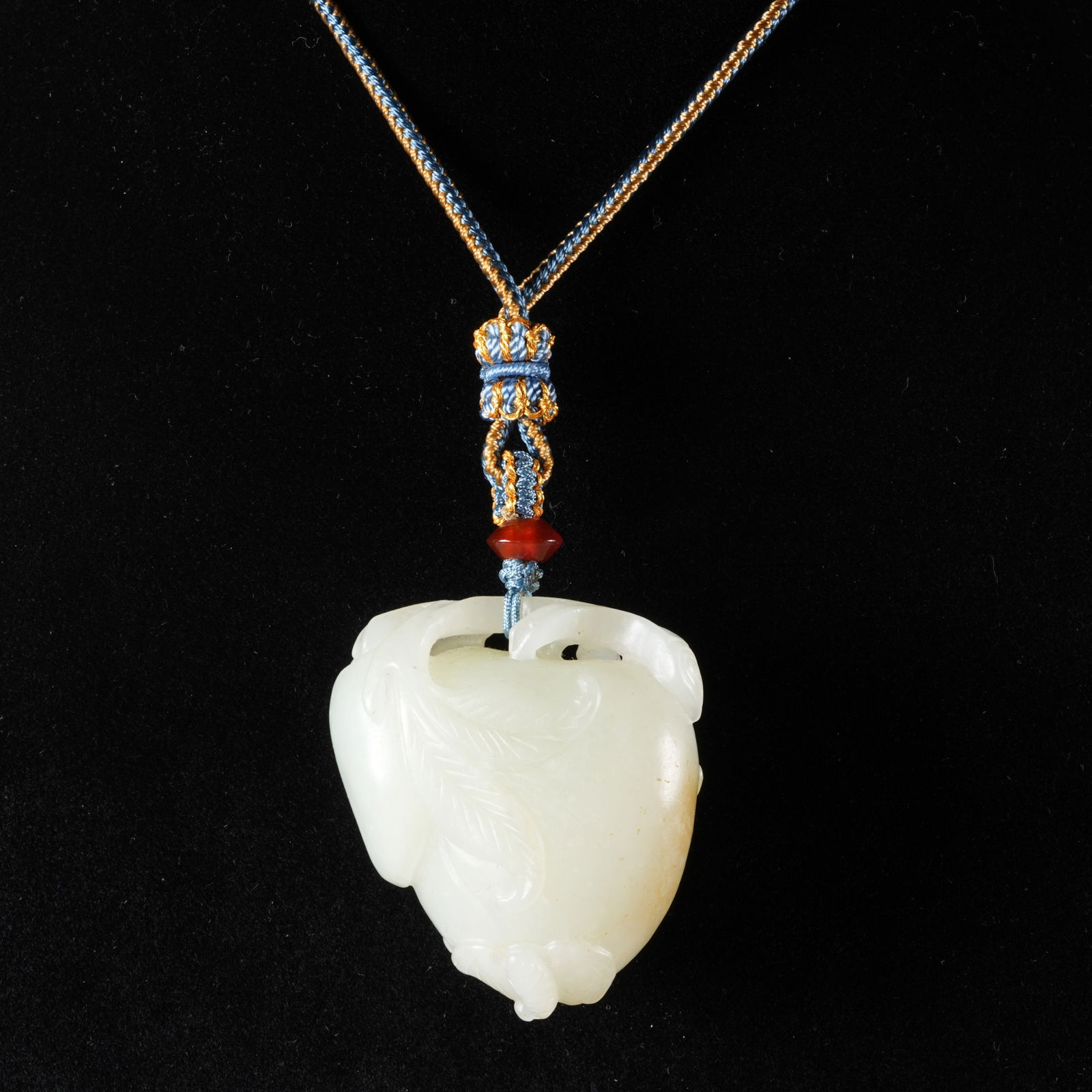 A HETIAN JADE PEACH-OF-LONGEVITY PENDANT: Hetian jade peach-of-longevity pendant