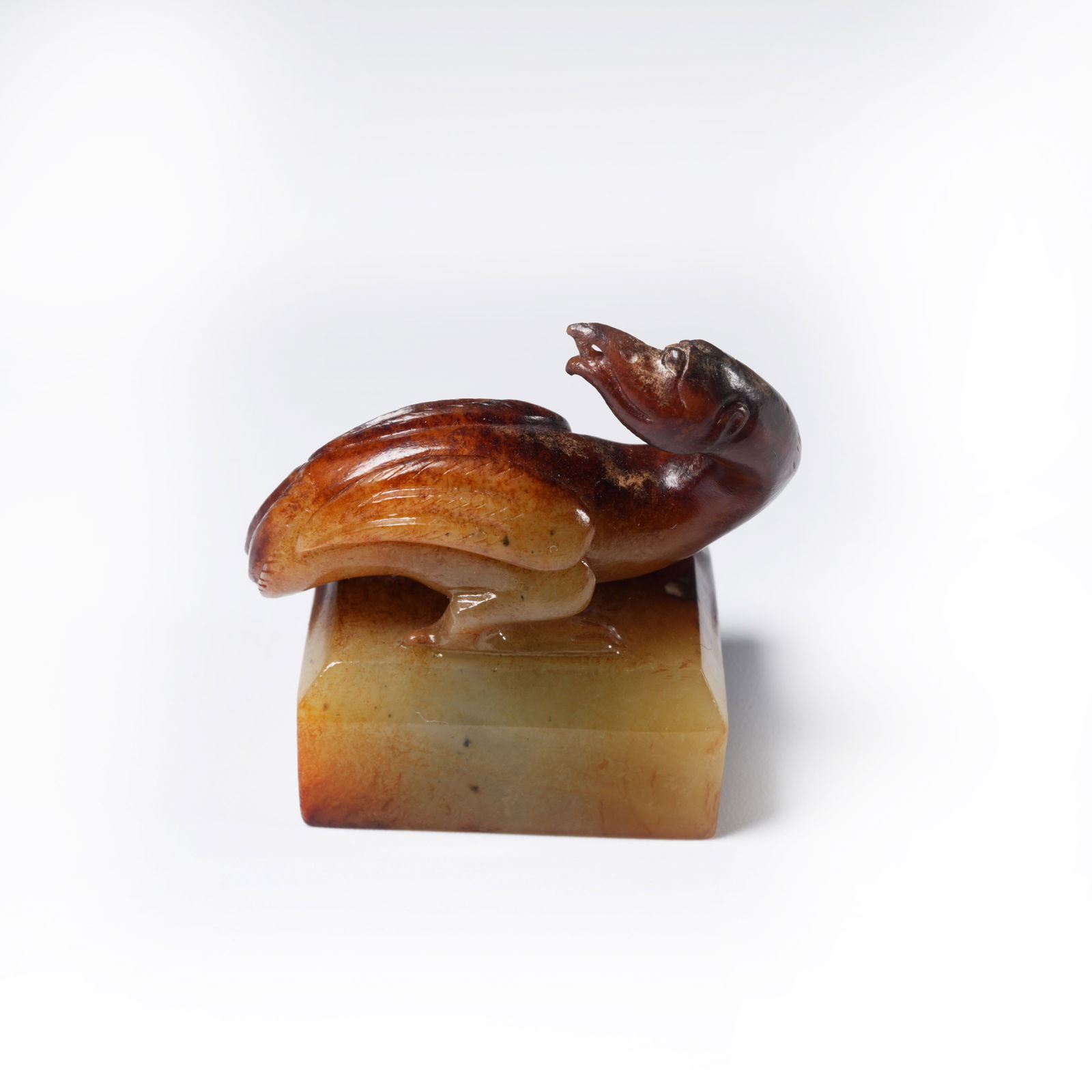 A ANCIENT JADE SEAL WITH BIRD-SHAPED KNOP: Ancient jade seal with bird-shaped knop