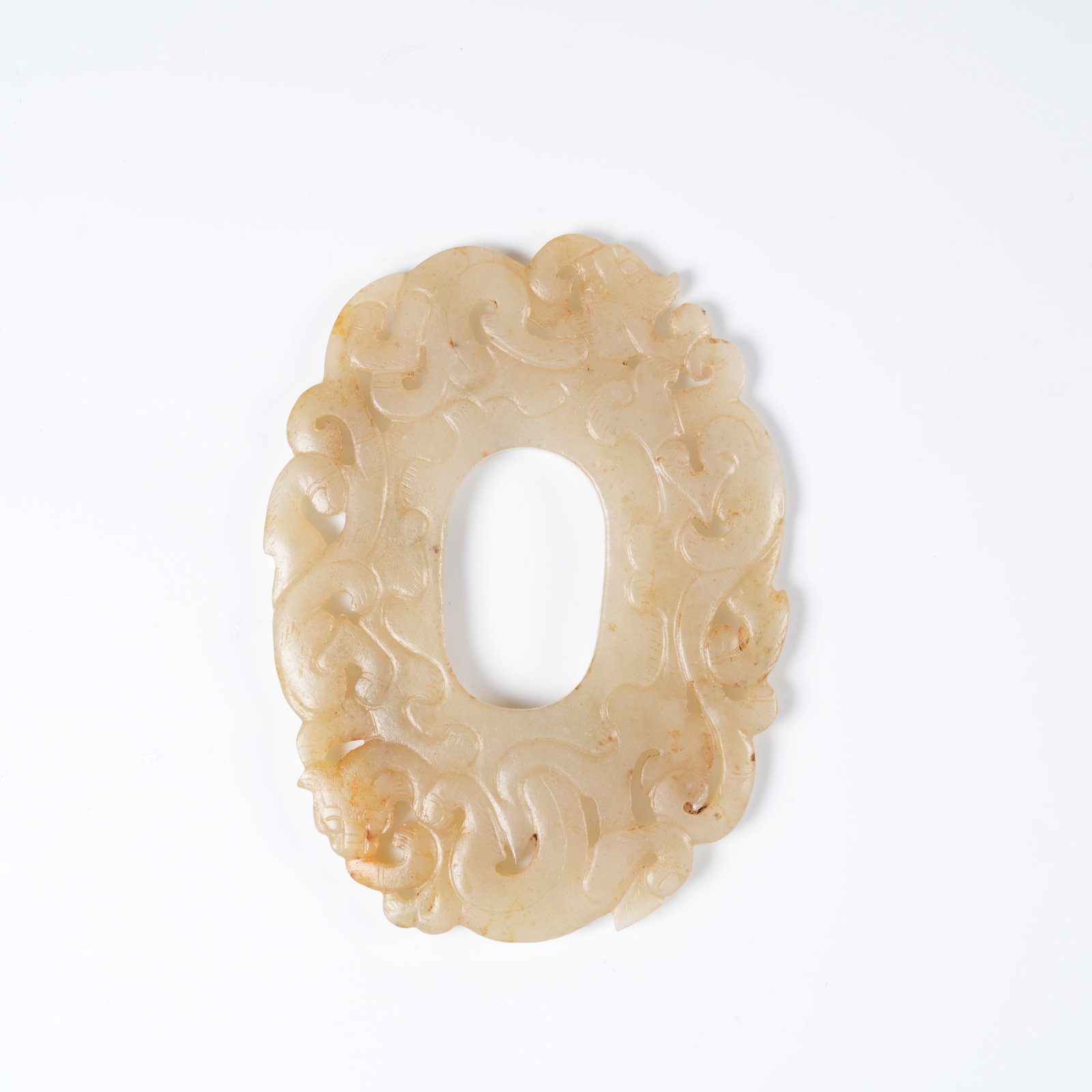 A ANCIENT JADE CHICKEN-HEART PENDANT WITH DRAGON MOTIF: Ancient jade chicken-heart pendant with dragon motif