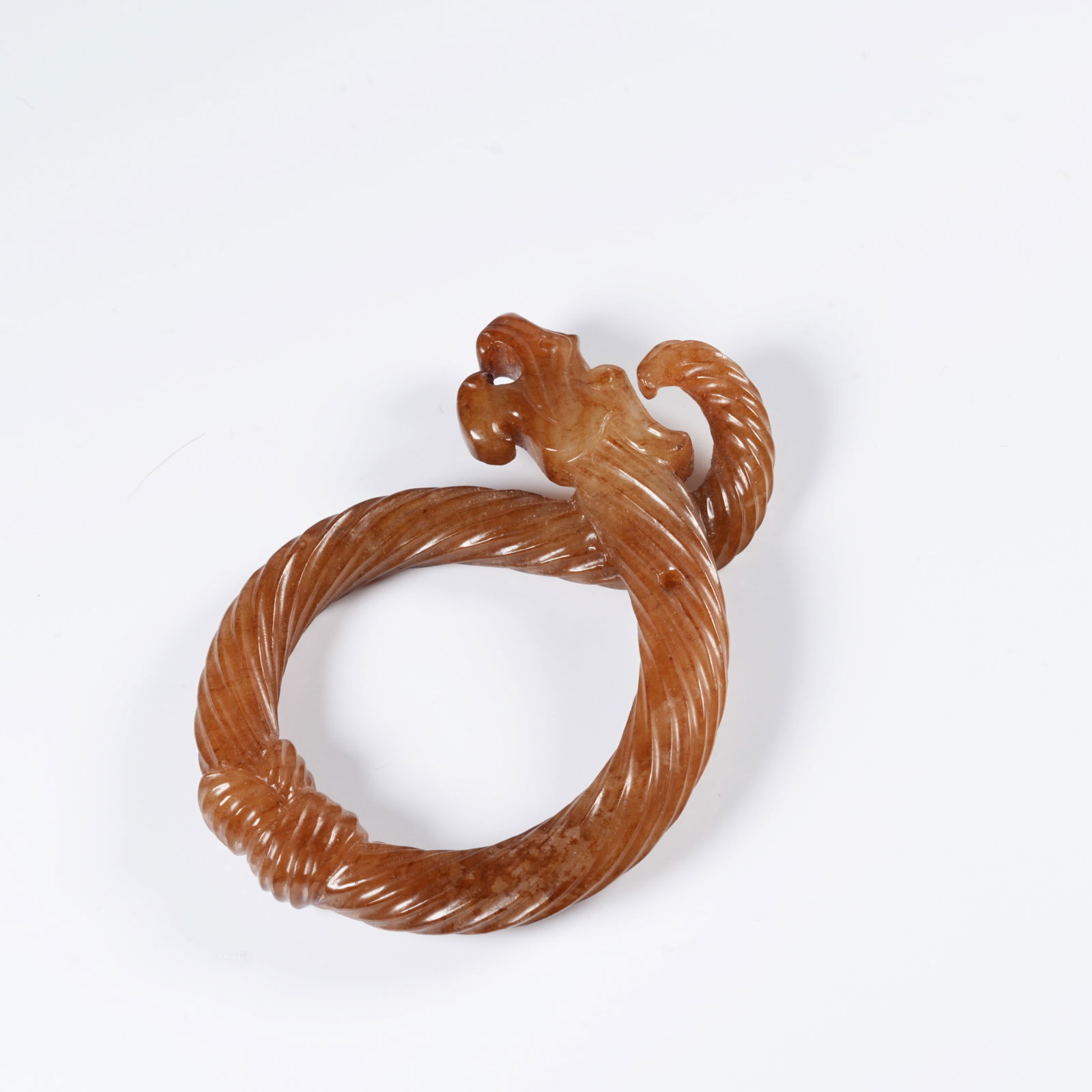 A ANCIENT JADE DRAGON-SHAPED RING: Ancient jade dragon-shaped ring