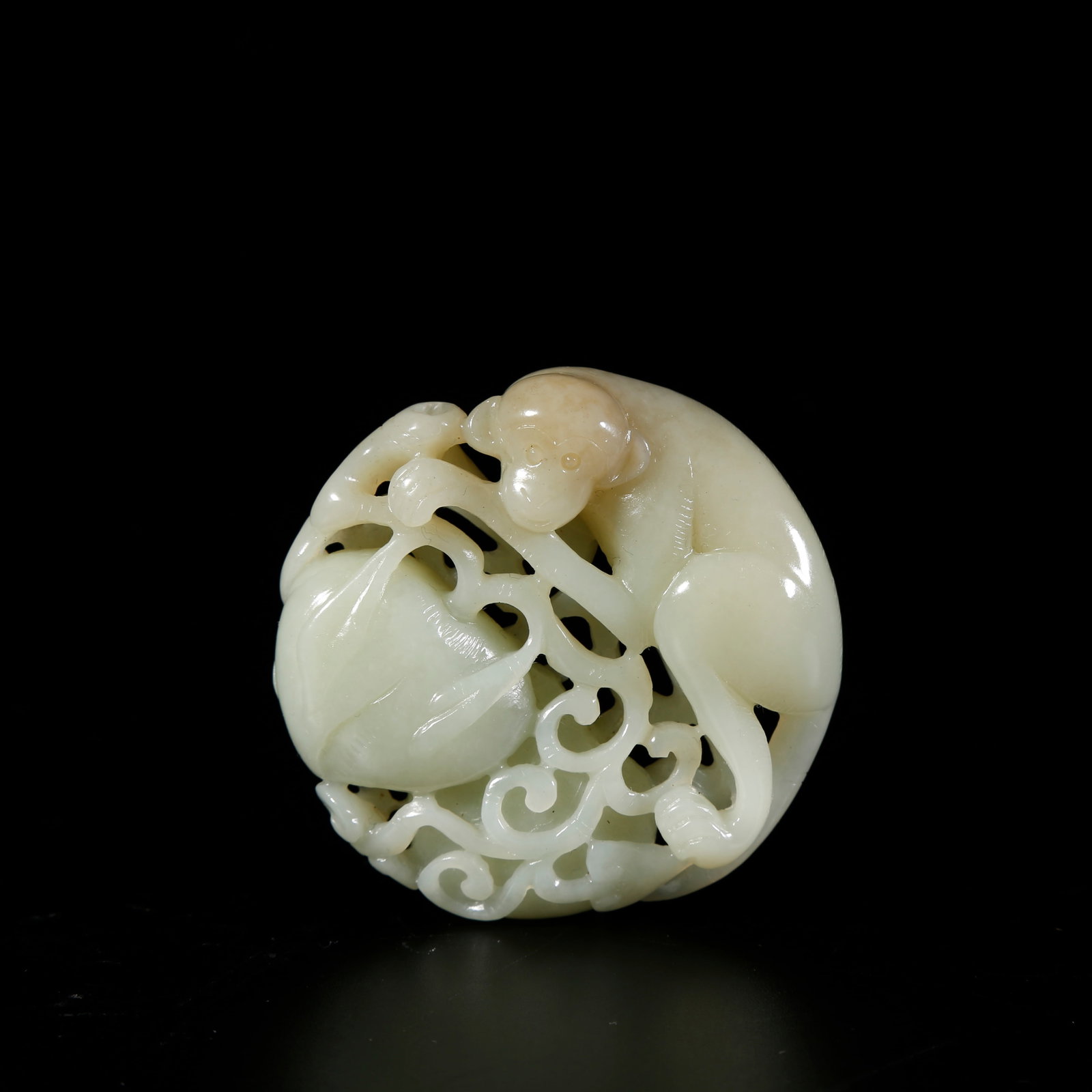 A HETIAN JADE PENDANT OF A MONKEY PRESENTING LONGEVITY: Hetian jade pendant of a monkey presenting longevity
