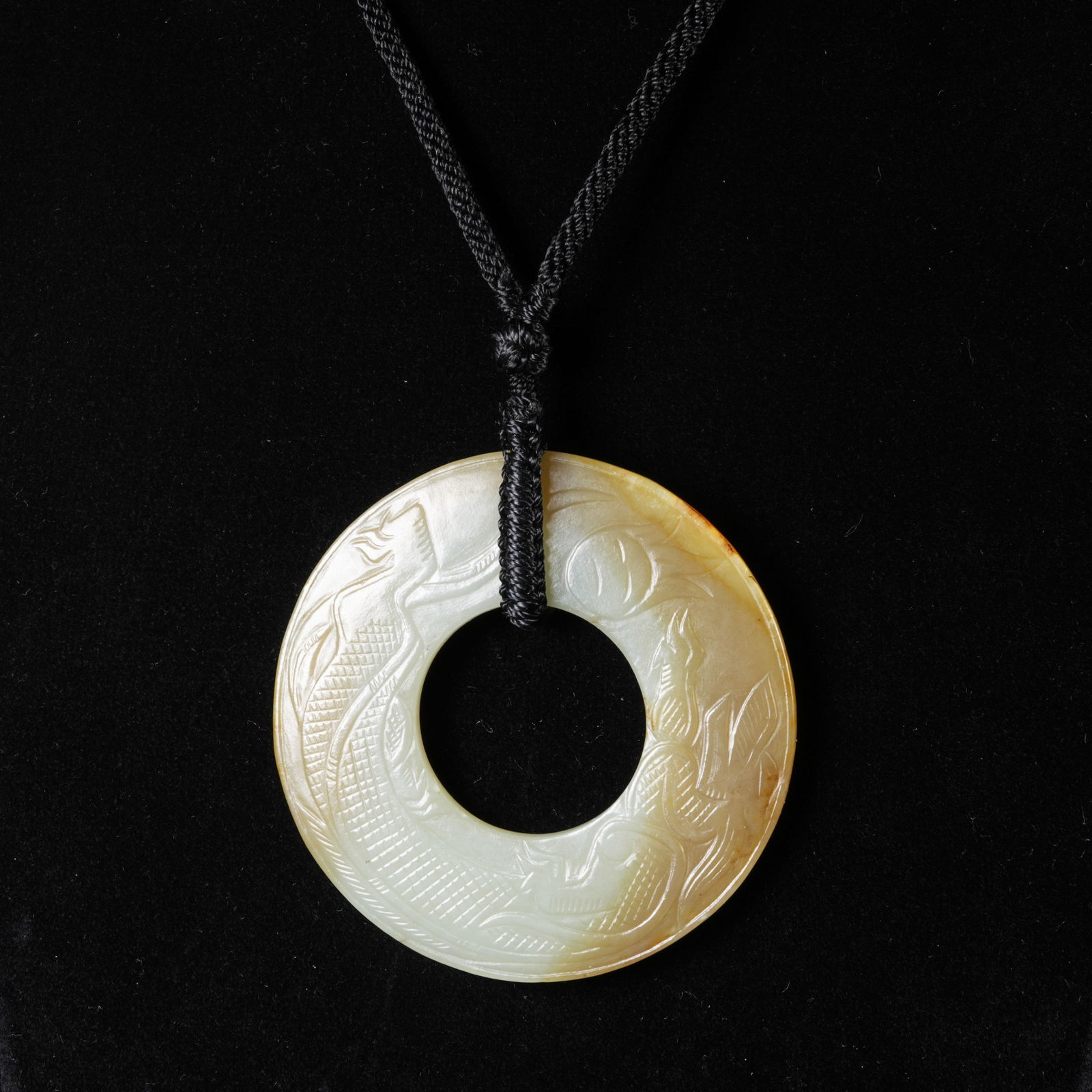 A HETIAN JADE RING WITH DRAGON MOTIF: Hetian jade ring with dragon motif