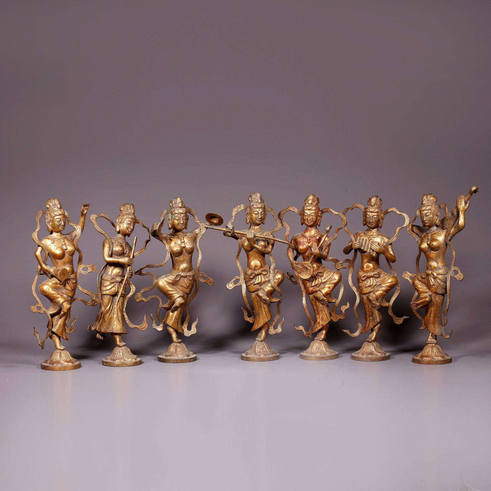 A GILT BRONZE FIGURINE SET WITH HUMAN FIGURES: Gilt Bronze Figurine Set with Human Figures