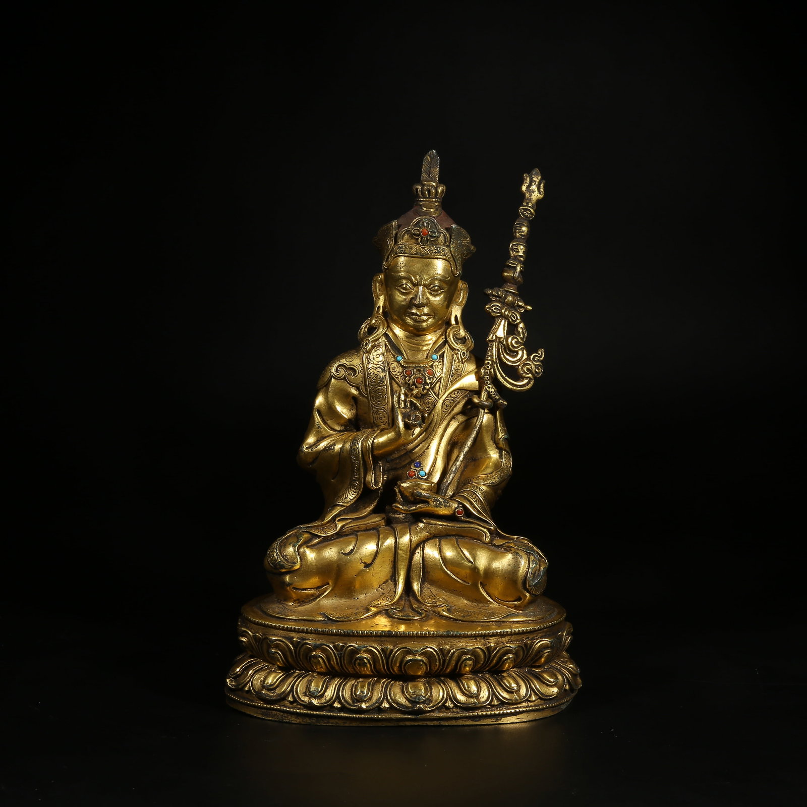 A GILT-BRONZE AND GEM-INLAID STATUE OF PADMASAMBHAVA: Gilt-Bronze and Gem-Inlaid Statue of Padmasambhava