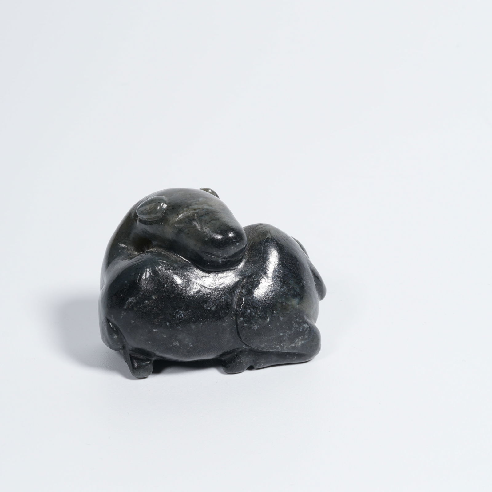 A HETIAN JADE AUSPICIOUS BEAST PENDANT: Hetian jade auspicious beast pendant