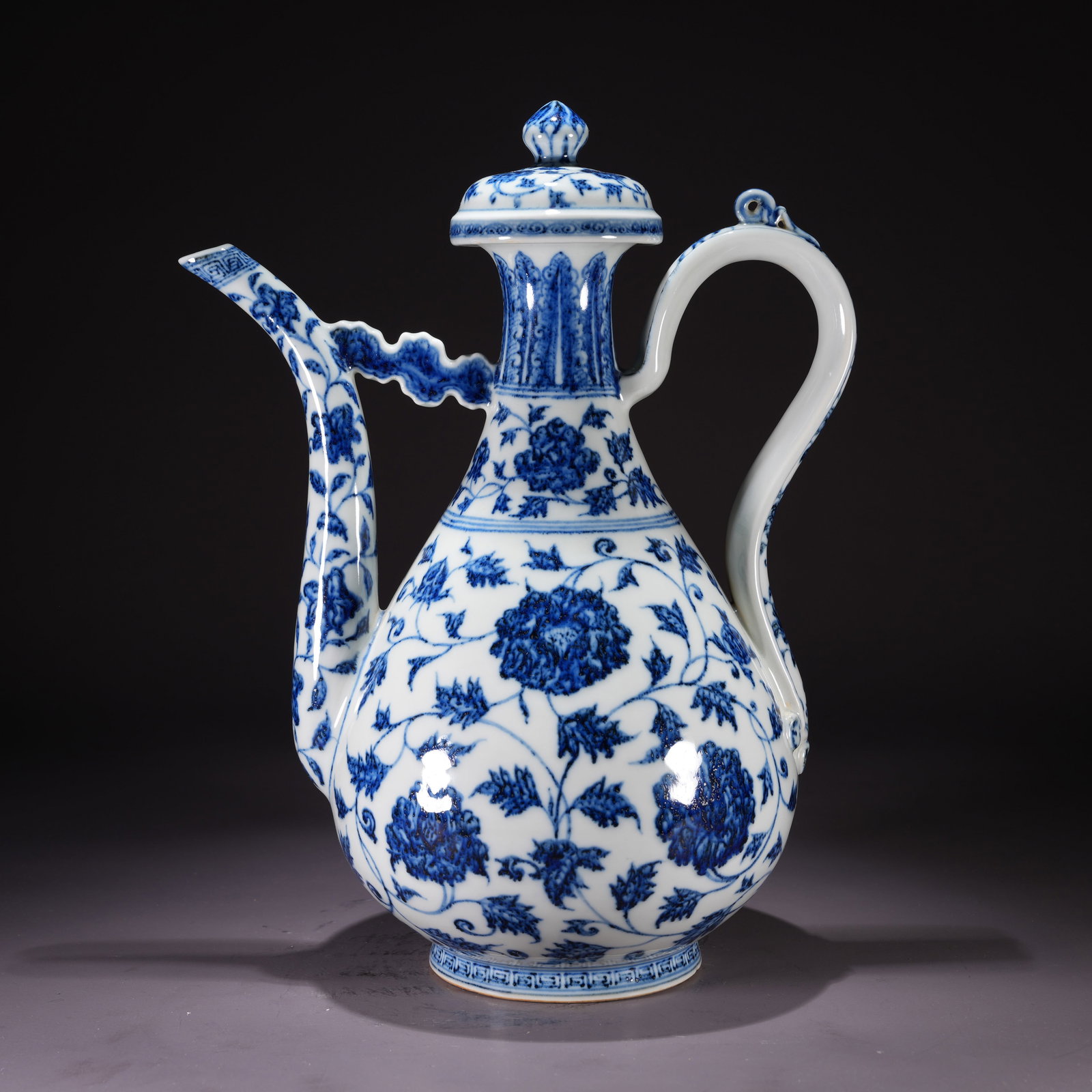 A BLUE-AND-WHITE EWER WITH FLORAL SCROLL MOTIF: Blue-and-White Ewer with Floral Scroll Motif
