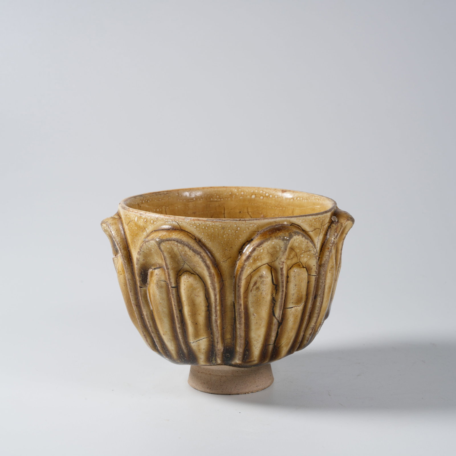 A YELLOW-GLAZED LOTUS CUP: Yellow-glazed lotus cup