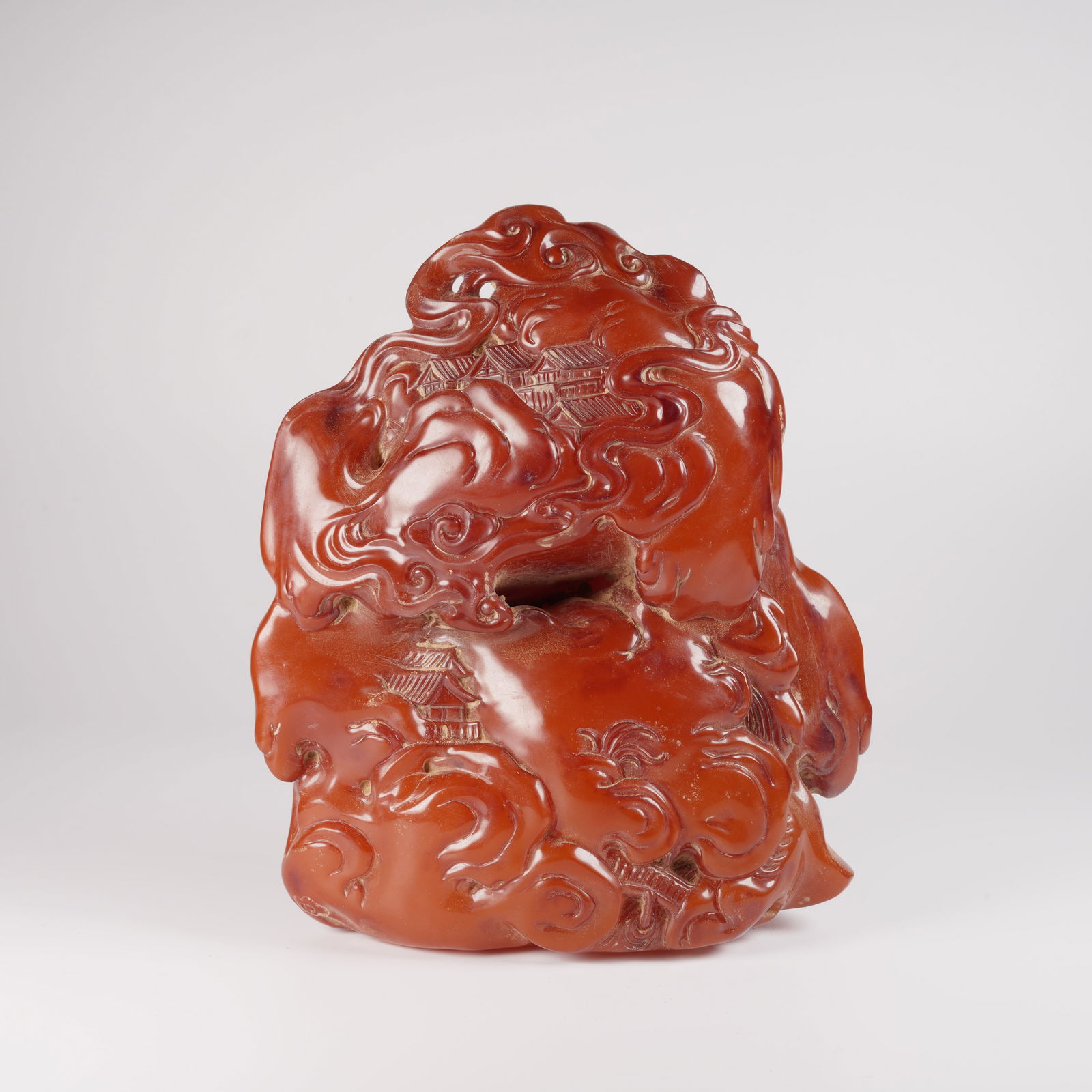 A HONEY-AMBER MOUNTAIN ORNAMENT WITH LANDSCAPE AND PAVILION MOTIFS: Honey-amber mountain ornament with landscape and pavilion motifs