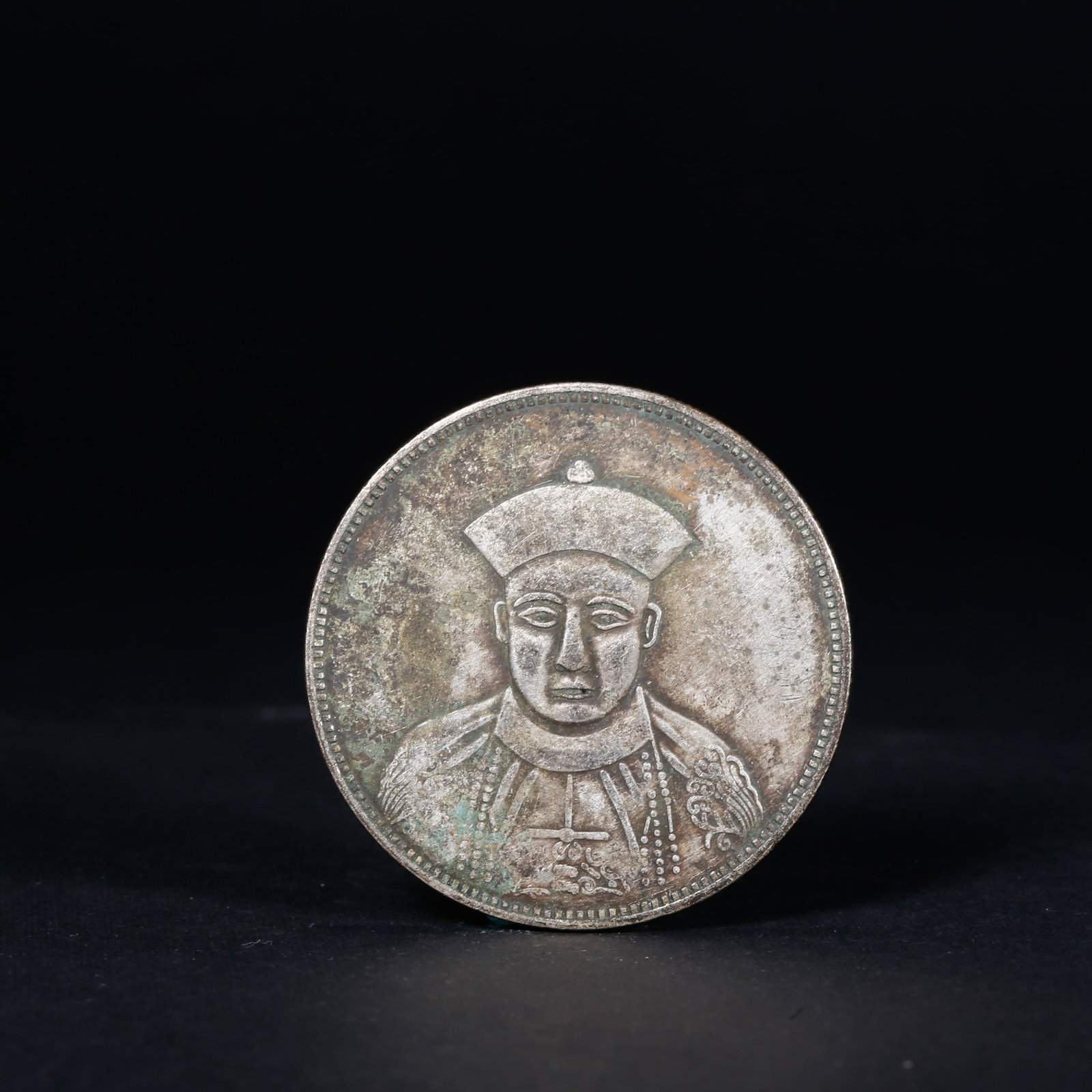 A SILVER DOLLAR COIN: One Silver dollar Coin