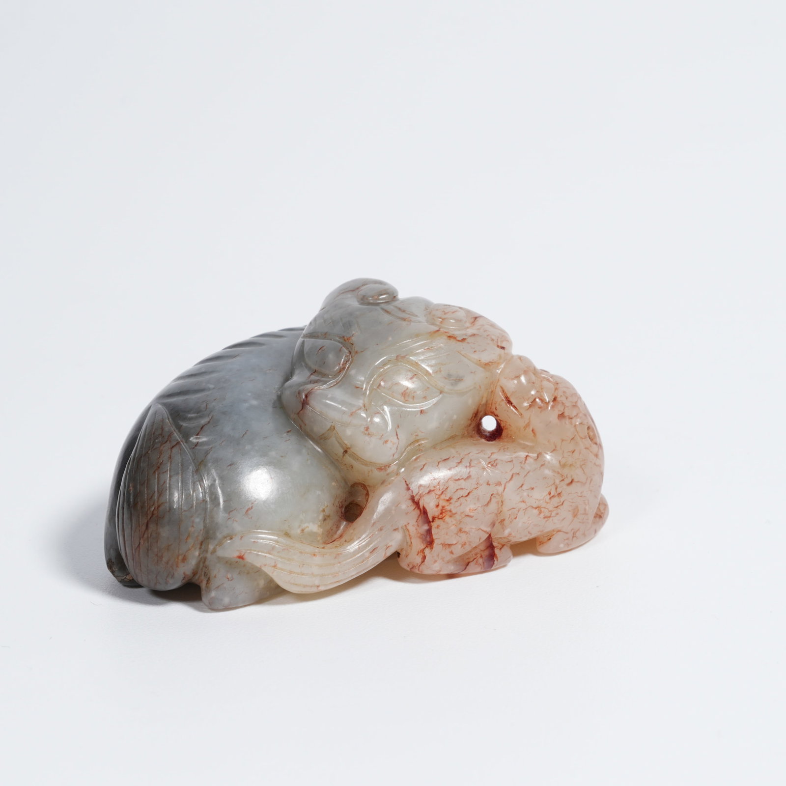 A HETIAN JADE "ADULT AND YOUNG LION" PENDANT: Hetian jade "adult and young lion" pendant