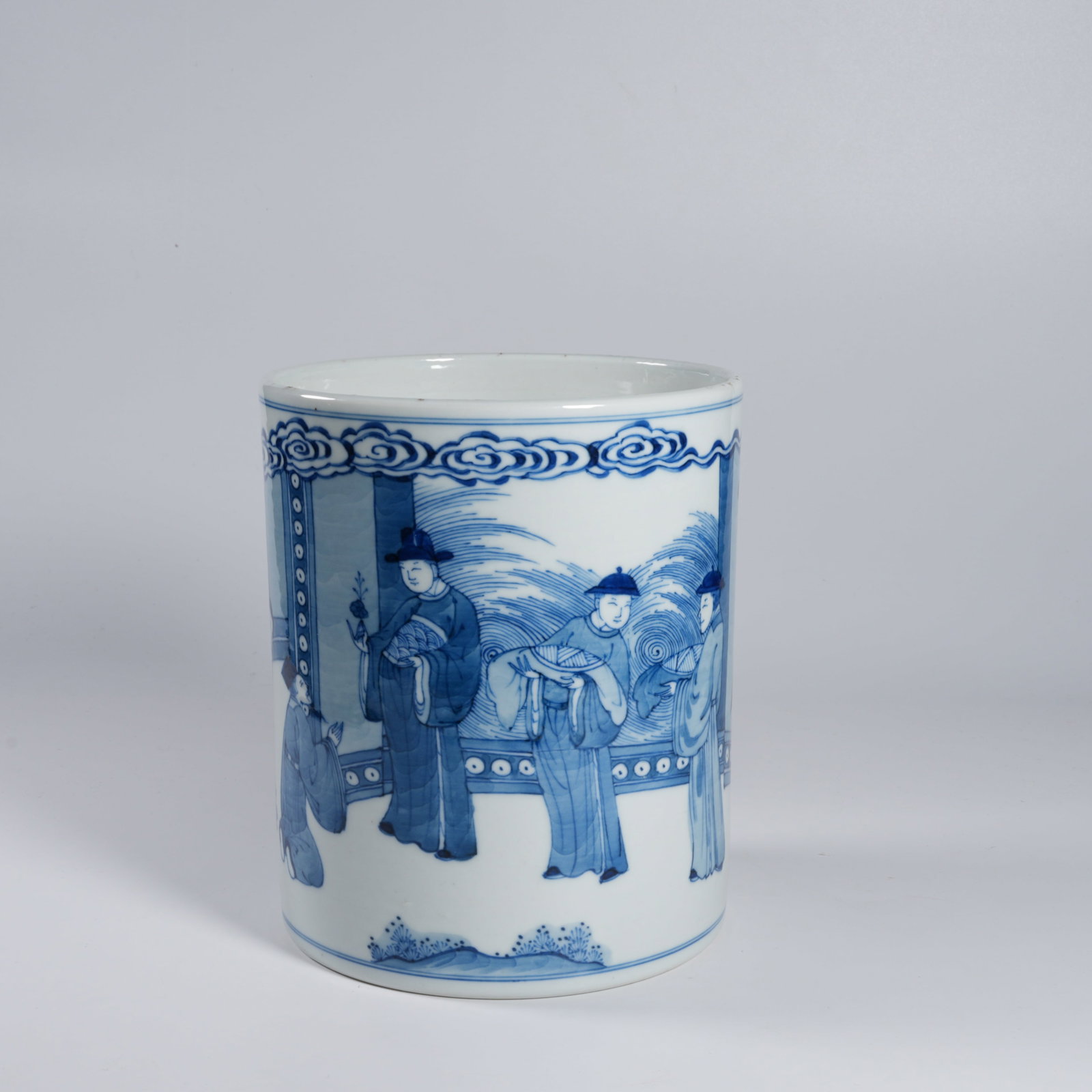 A BLUE-AND-WHITE FIGURAL BRUSH POT: Blue-and-white figural brush pot