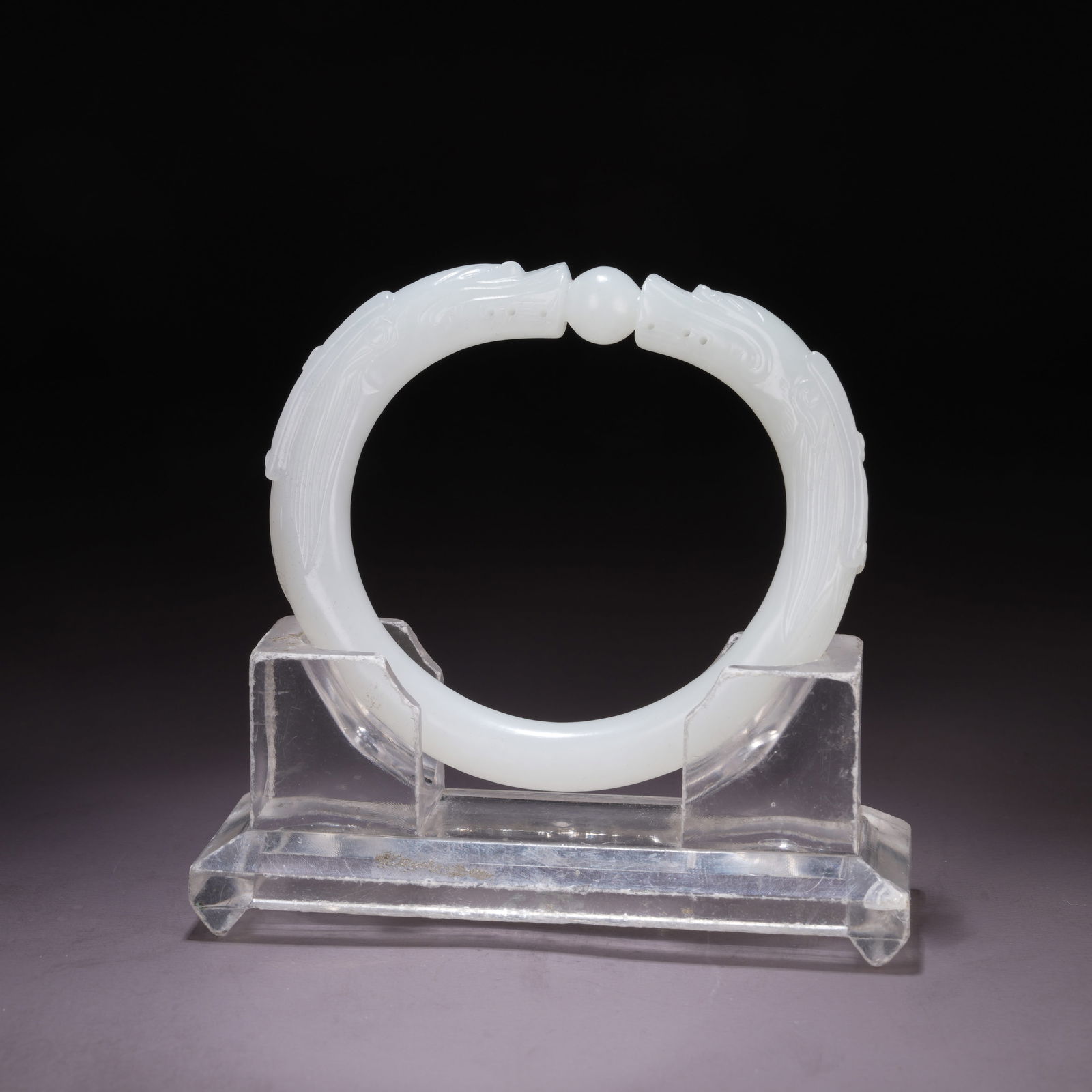 A HETIAN WHITE JADE BRACELET WITH TWIN DRAGONS PLAYING WITH A PEARL: Hetian White Jade Bracelet with Twin Dragons Playing with a Pearl