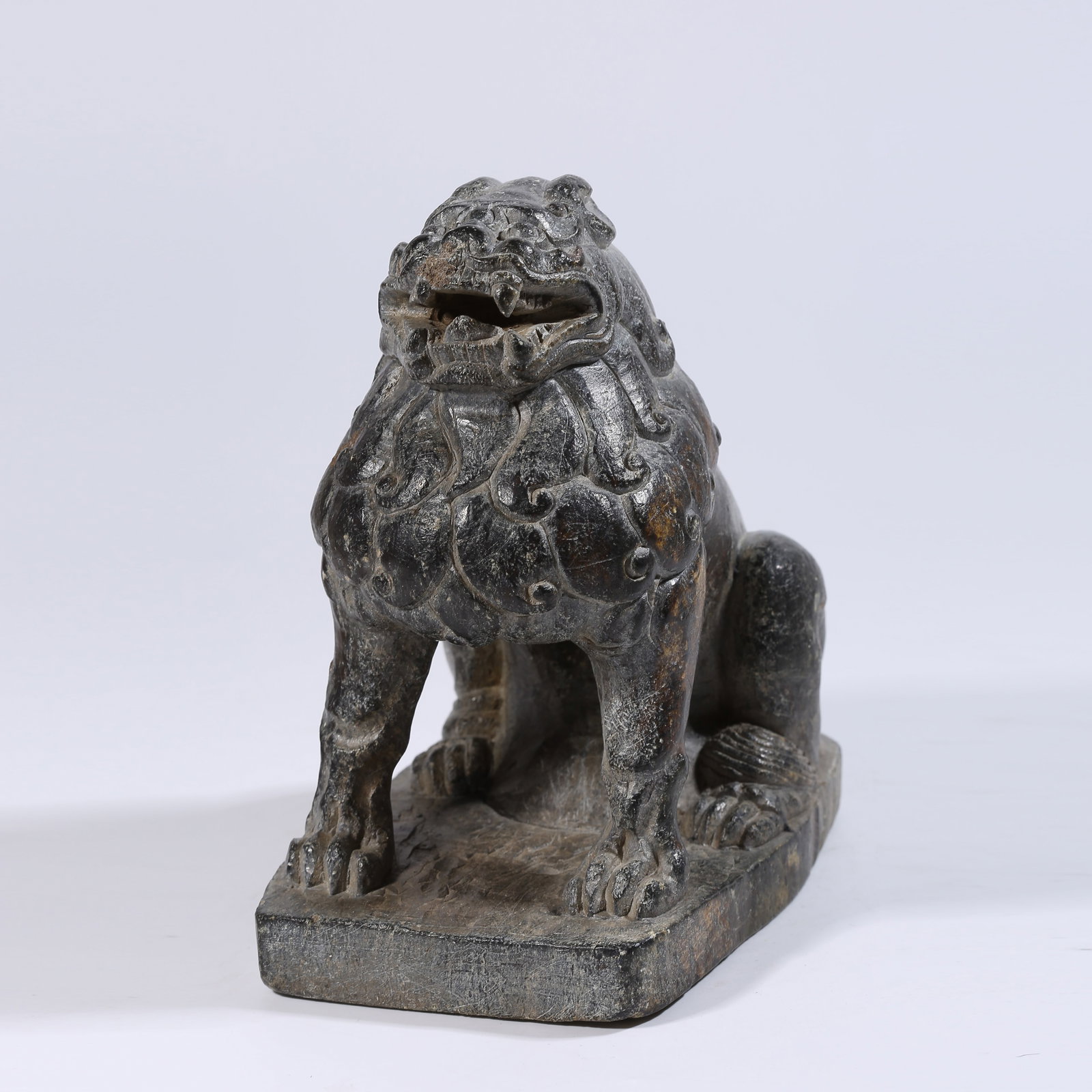 A STONE SEATED LION: Stone seated lion