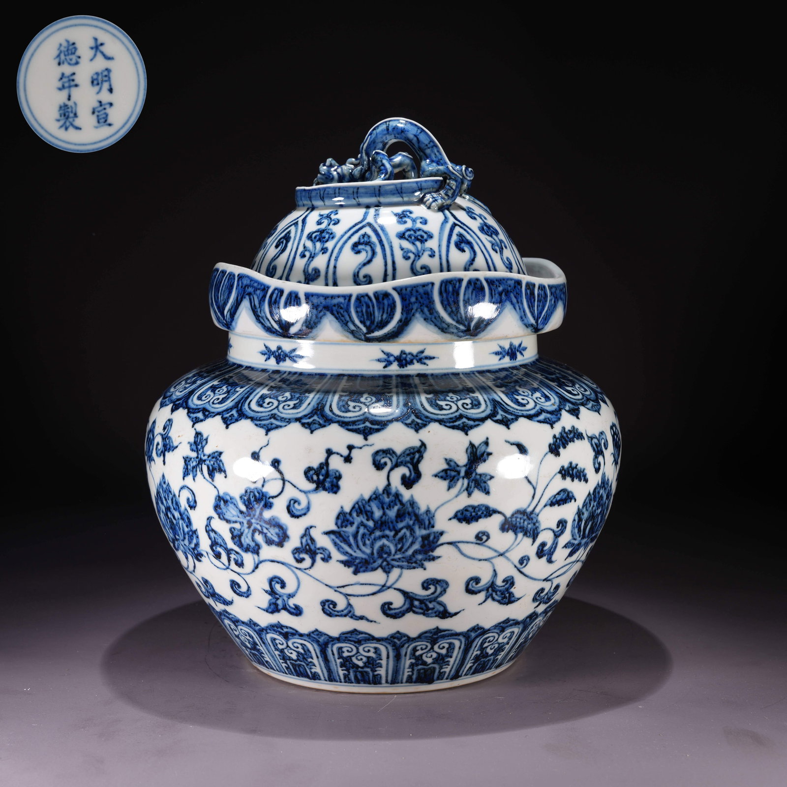 A BLUE-AND-WHITE COVERED JAR WITH FLORAL SCROLL MOTIF AND CHI-DRAGON KNOB: Blue-and-White Covered Jar with Floral Scroll Motif and Chi-Dragon Knob