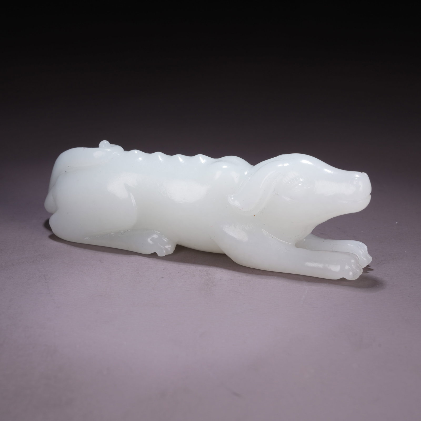 A HETIAN WHITE JADE AUSPICIOUS DOG HANDHELD ORNAMENT: Hetian White Jade Auspicious Dog Handheld Ornament