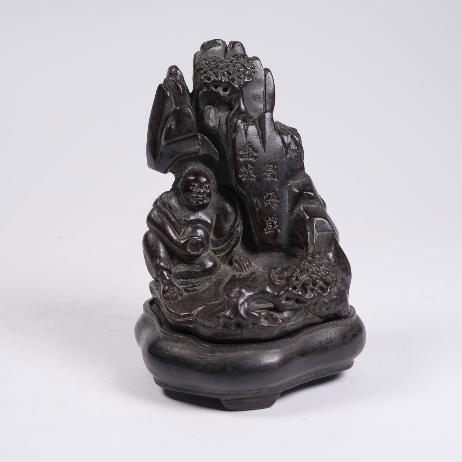A ZITAN FIGURINE OF MONK UNDER PINES: Zitan Figurine of Monk under Pines