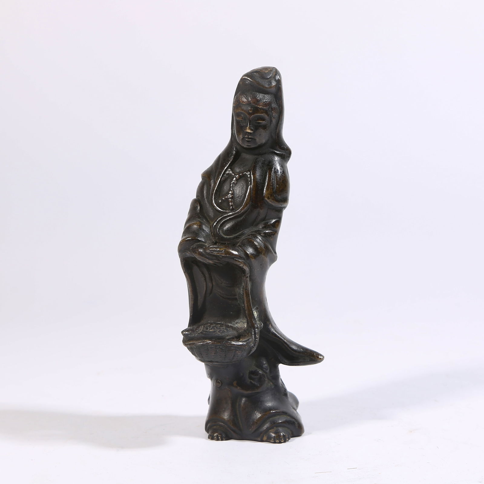 A BRONZE FISH-BASKET GUANYIN: Bronze fish-basket Guanyin