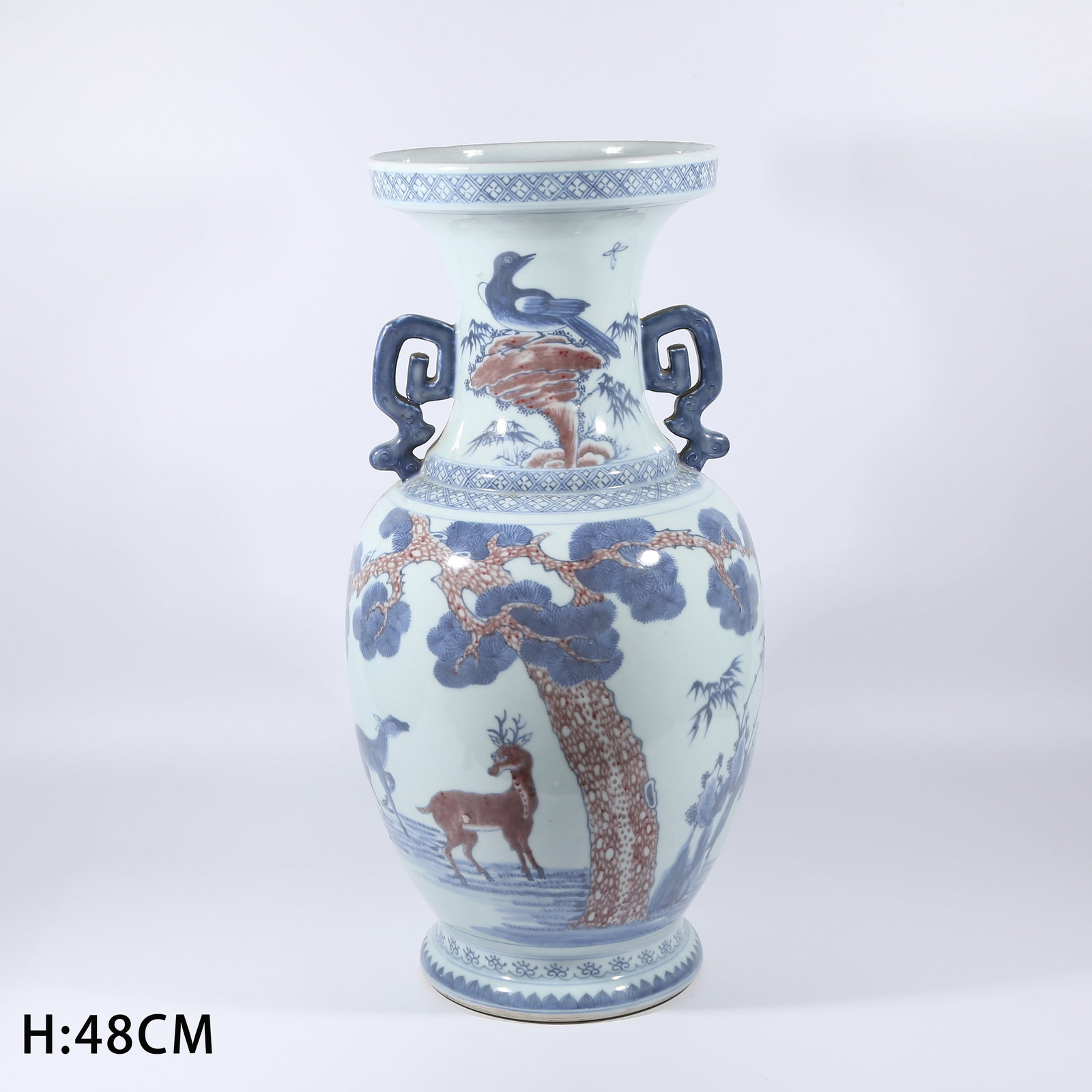 A BLUE AND WHITE WITH UNDERGLAZE RED VASE WITH PINE-AND-DEER DESIGN AND EVERTED RIM: Blue and White with Underglaze Red Vase with Pine-and-Deer Design and Everted Rim