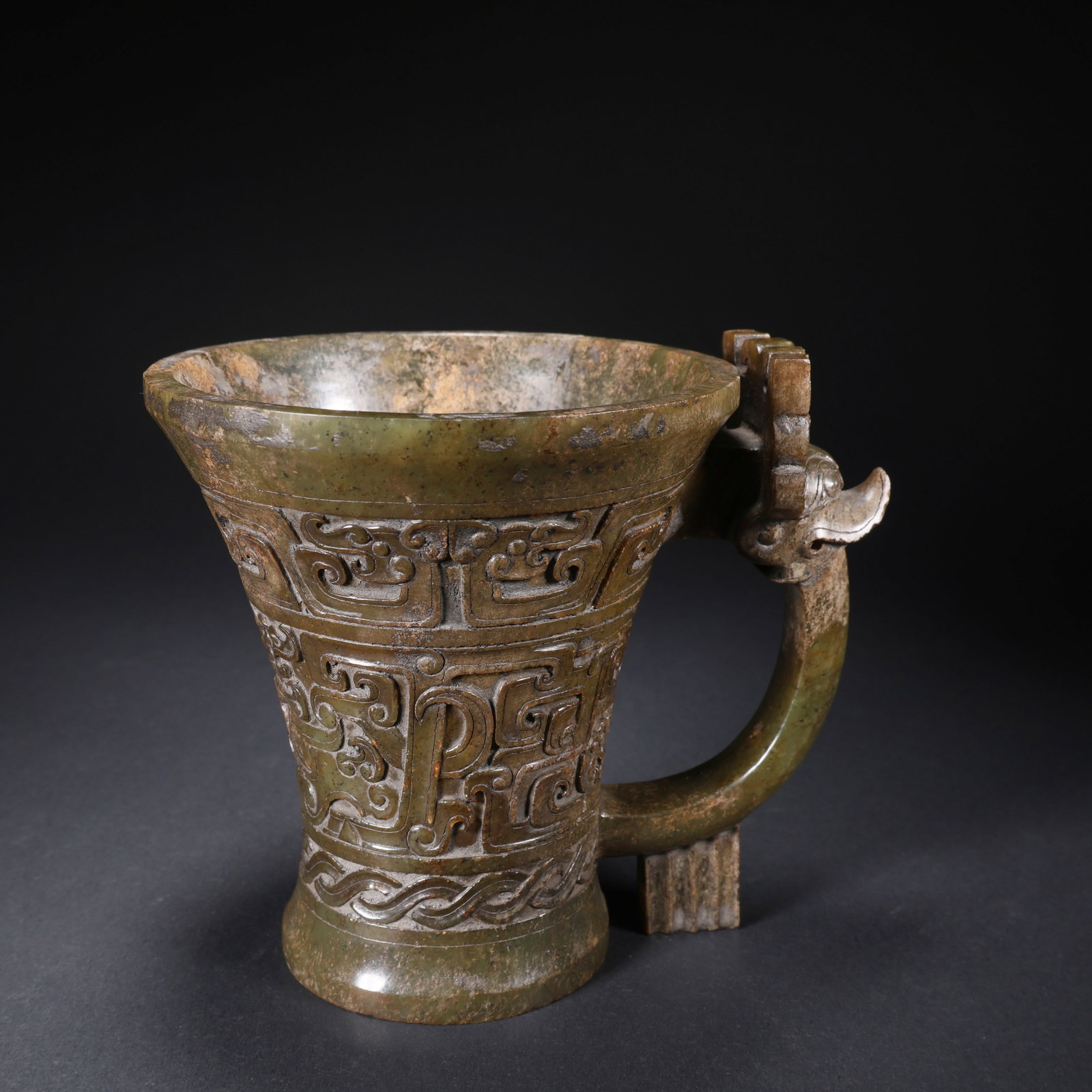 A HETIAN JADE DRAGON-HANDLED CUP WITH BEAST FACES: Hetian Jade Dragon-Handled Cup with Beast Faces