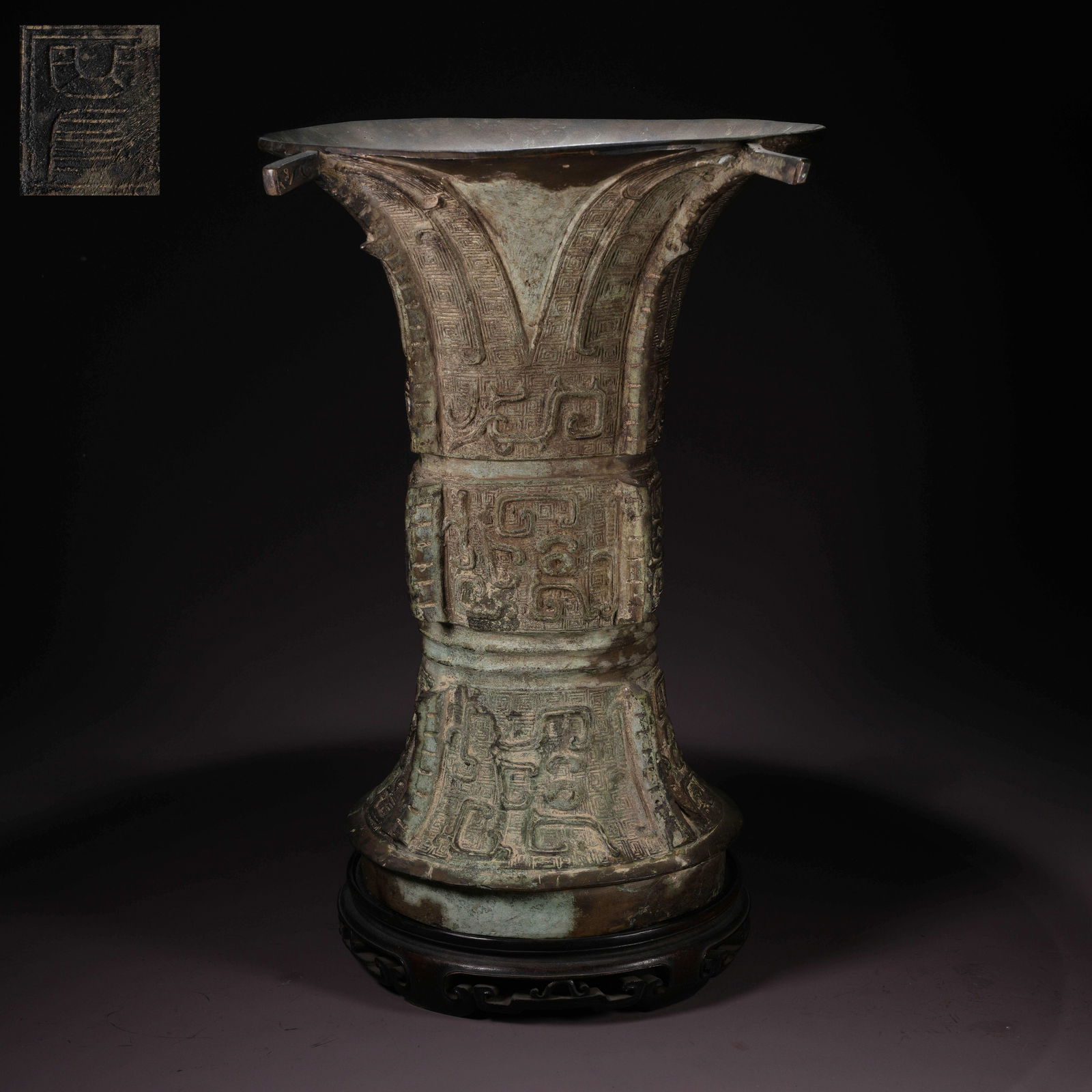 A LARGE BRONZE GU VASE WITH TAOTIE MASK AND FLANGED PROJECTIONS: Large Bronze Gu Vase with Taotie Mask and Flanged Projections