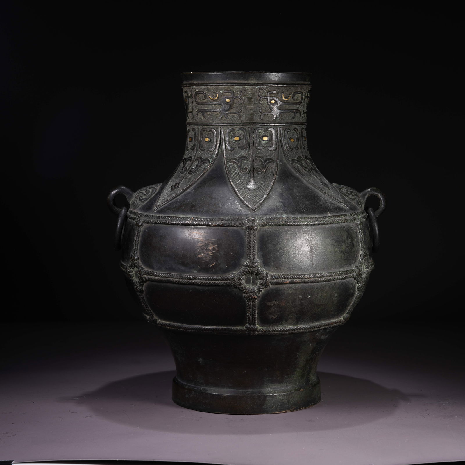 A BRONZE HU VESSEL WITH TAOTIE MASK AND RING HANDLES: Bronze Hu Vessel with Taotie Mask and Ring Handles