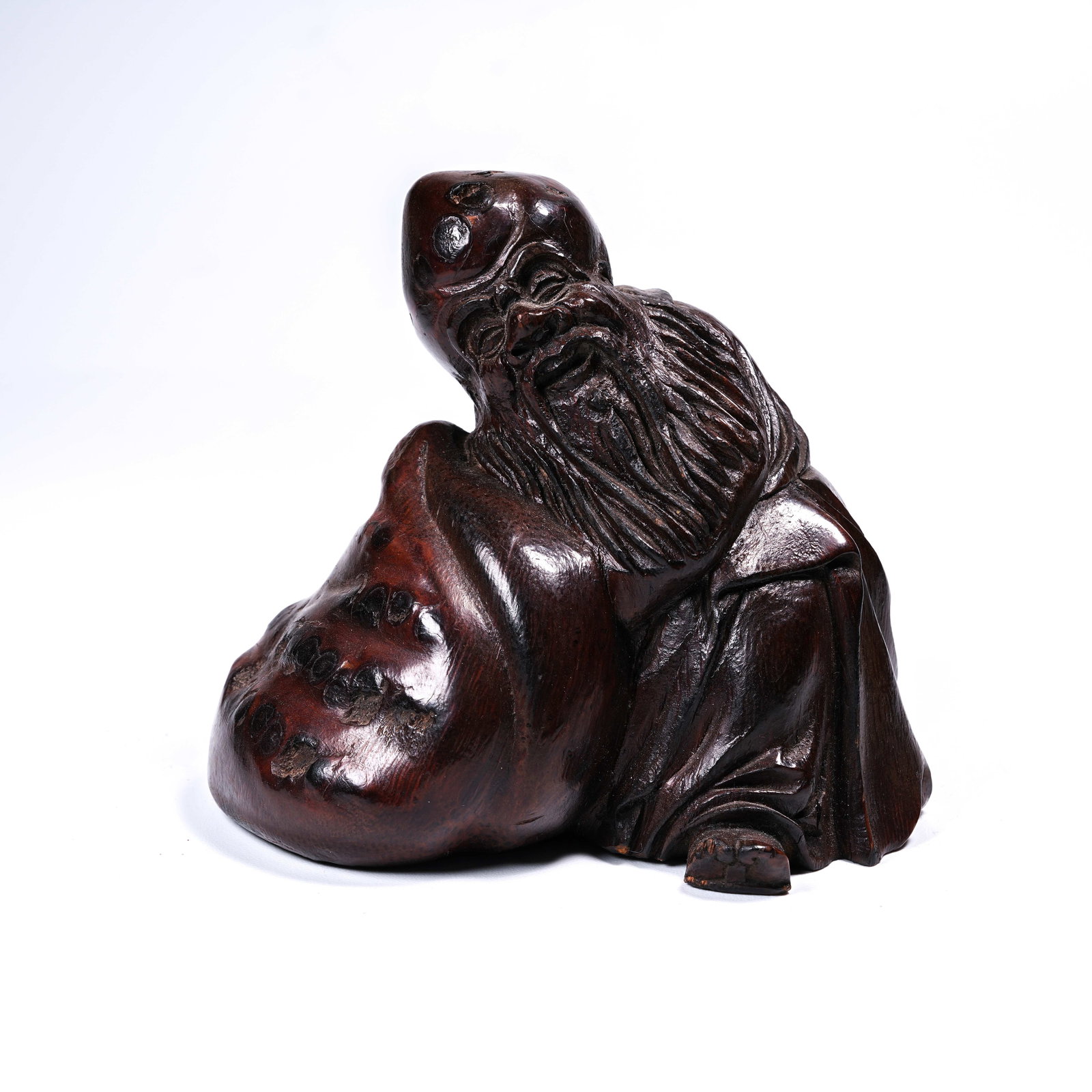 A BAMBOO ROOT CARVED LONGEVITY DEITY FIGURINE (1 of 8)