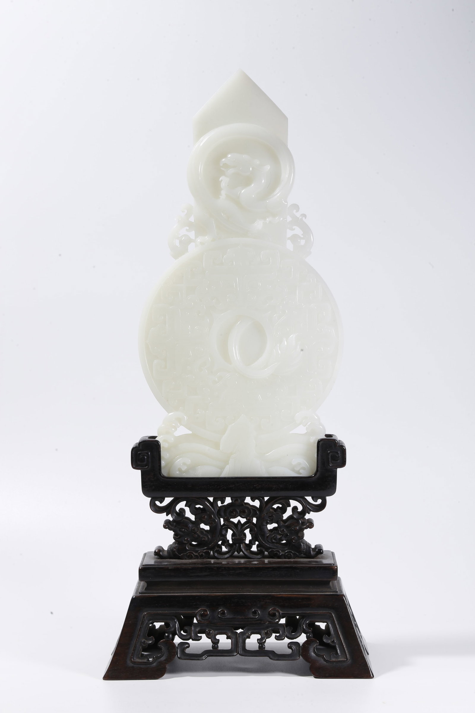 A HETIAN JADE CARVED GUI-BI WITH BEAST MASK AND DRAGON MOTIF (1 of 9)