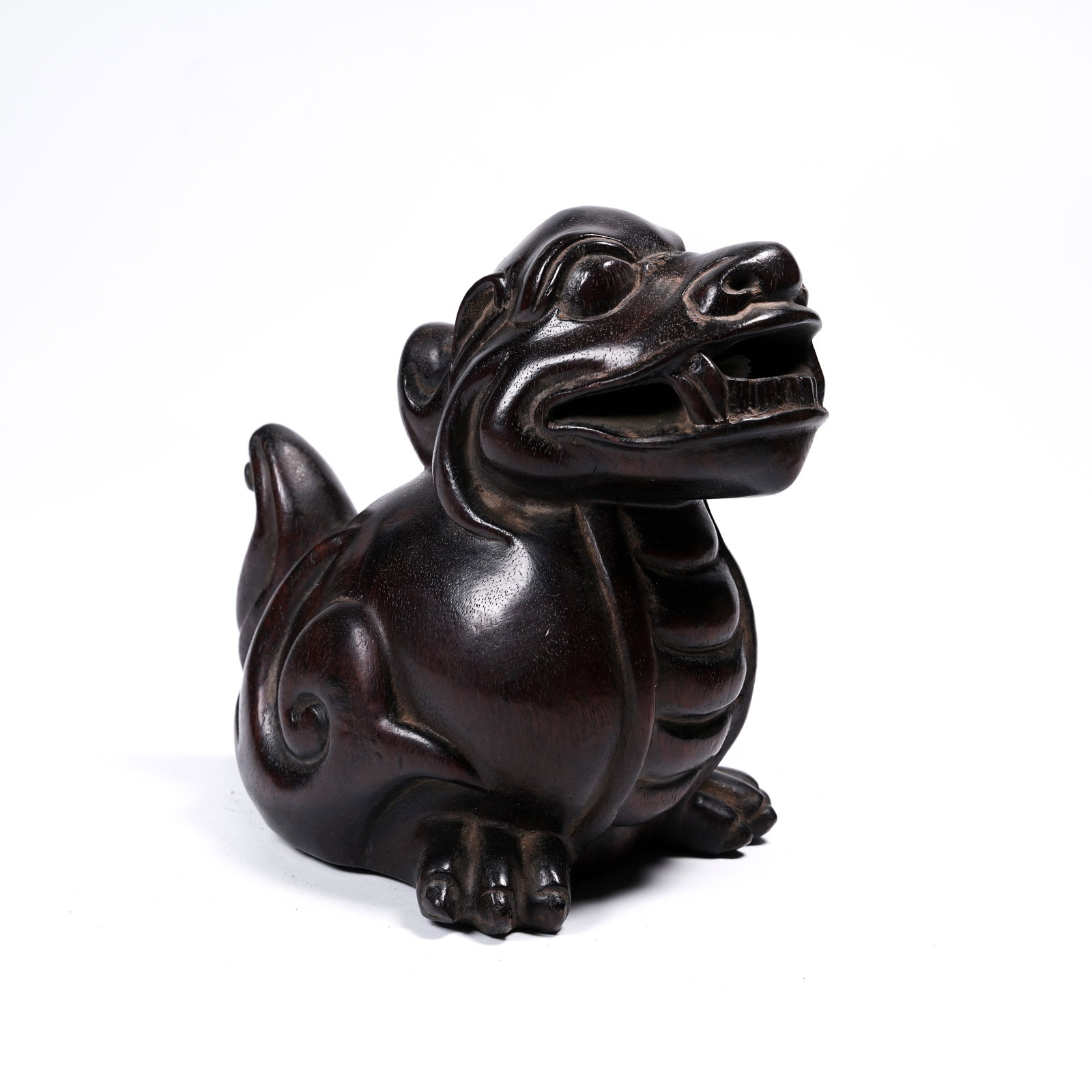 A ZITAN (RED SANDALWOOD) AUSPICIOUS BEAST PAPERWEIGHT: Zitan (red sandalwood) auspicious beast paperweight