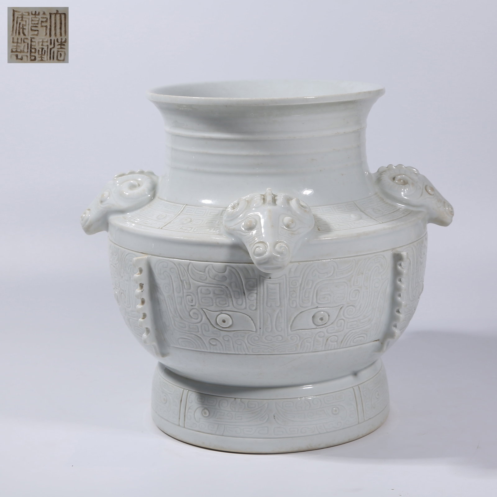 A WHITE-GLAZED BEAST-FACE PATTERN FOUR-SHEEP ZUN WITH PROTRUDING SPEAR MOTIF: White-glazed beast-face pattern four-sheep zun with protruding spear motif