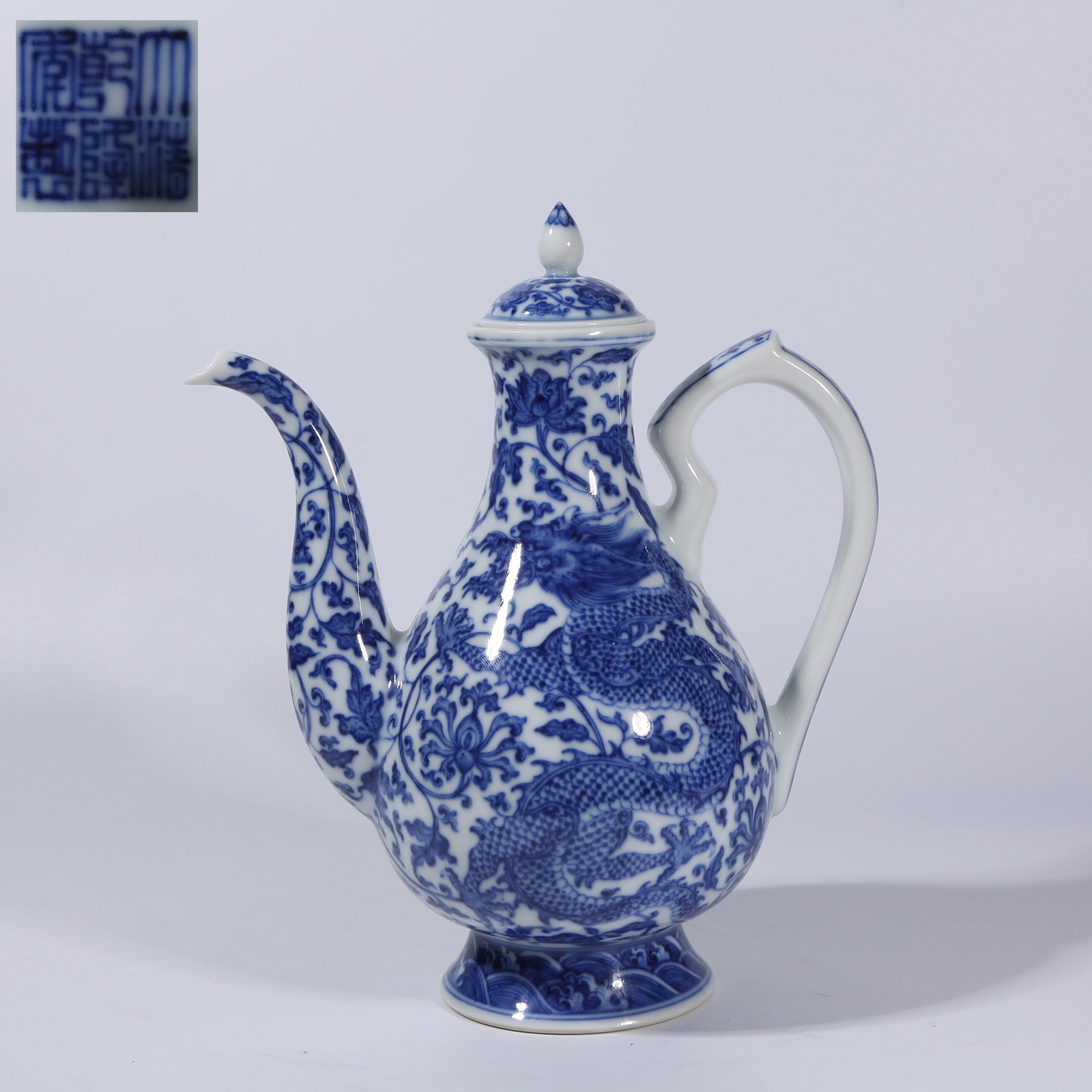 A BLUE AND WHITE "DRAGON THROUGH FLOWERS" EWER: Blue and white "dragon through flowers" ewer