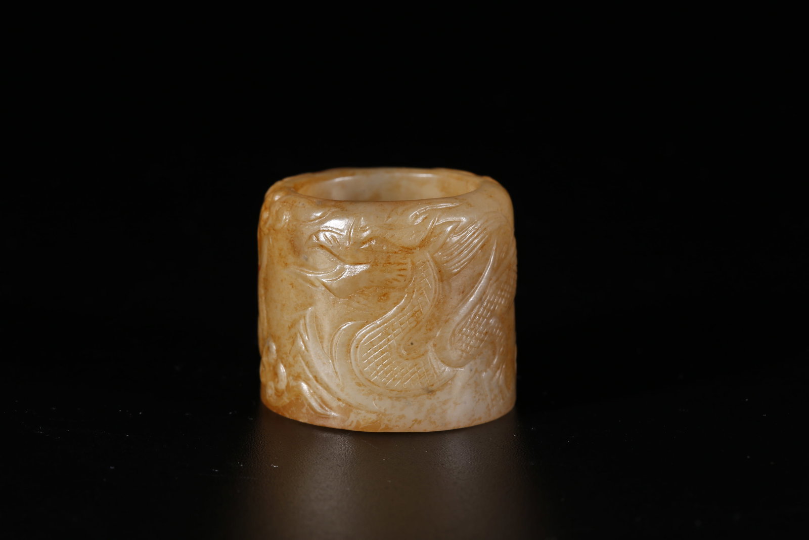 A HETIAN JADE CARVED THUMB RING WITH CLOUD-AND-DRAGON MOTIF (1 of 8)