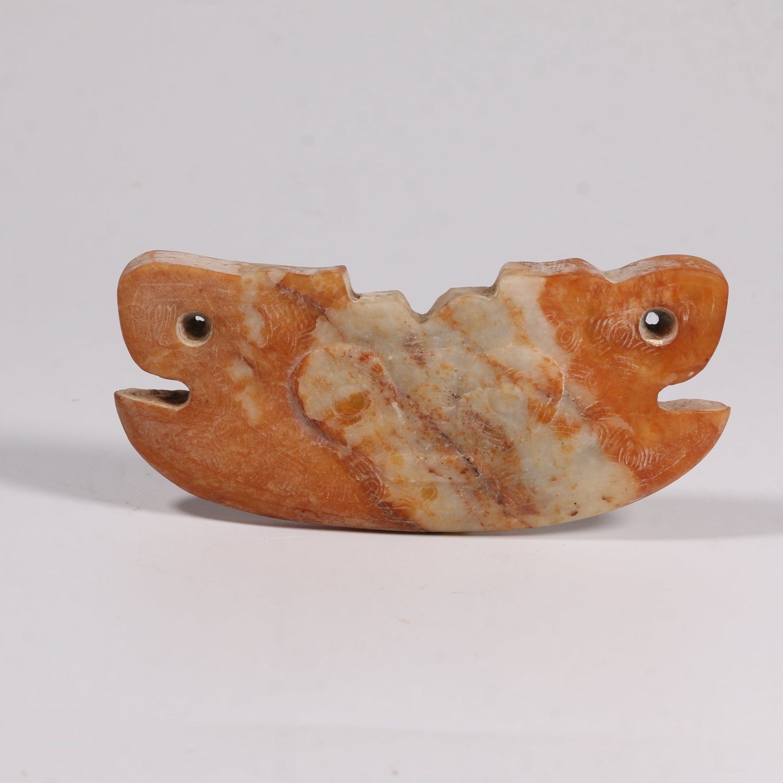 A ARCHAIC JADE BEAST-MASK ORNAMENT (1 of 8)